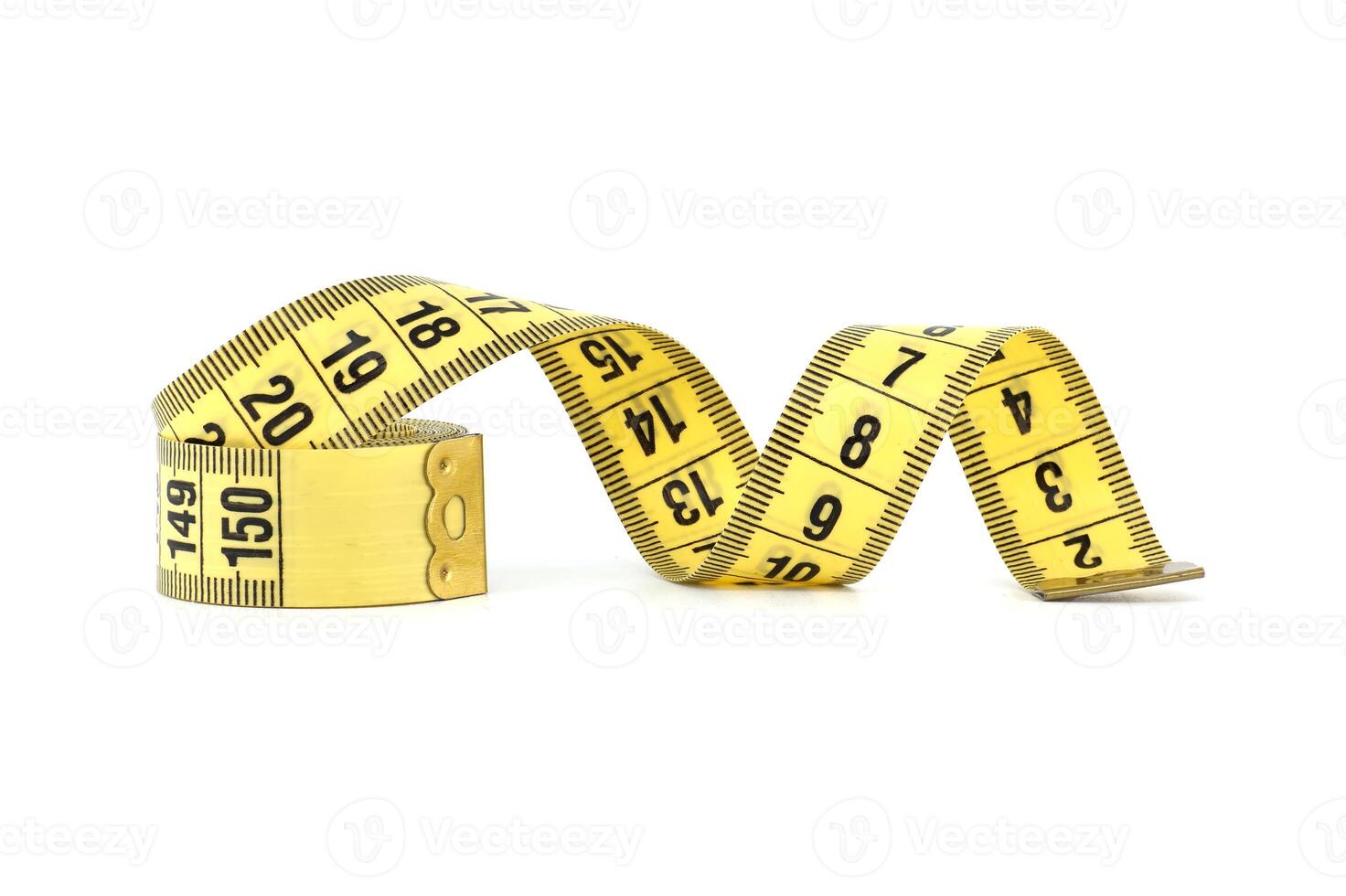 Yellow measuring tape, spirals gracefully, isolated on white photo