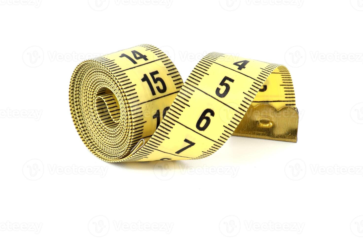 Yellow measuring tape, spirals gracefully, isolated on white photo