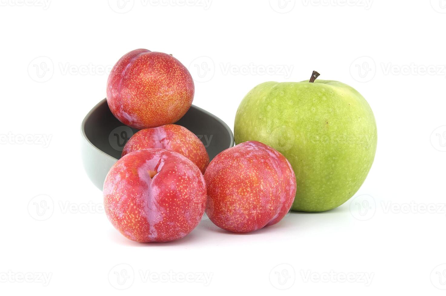 Red plums and green apple isolated on white background photo
