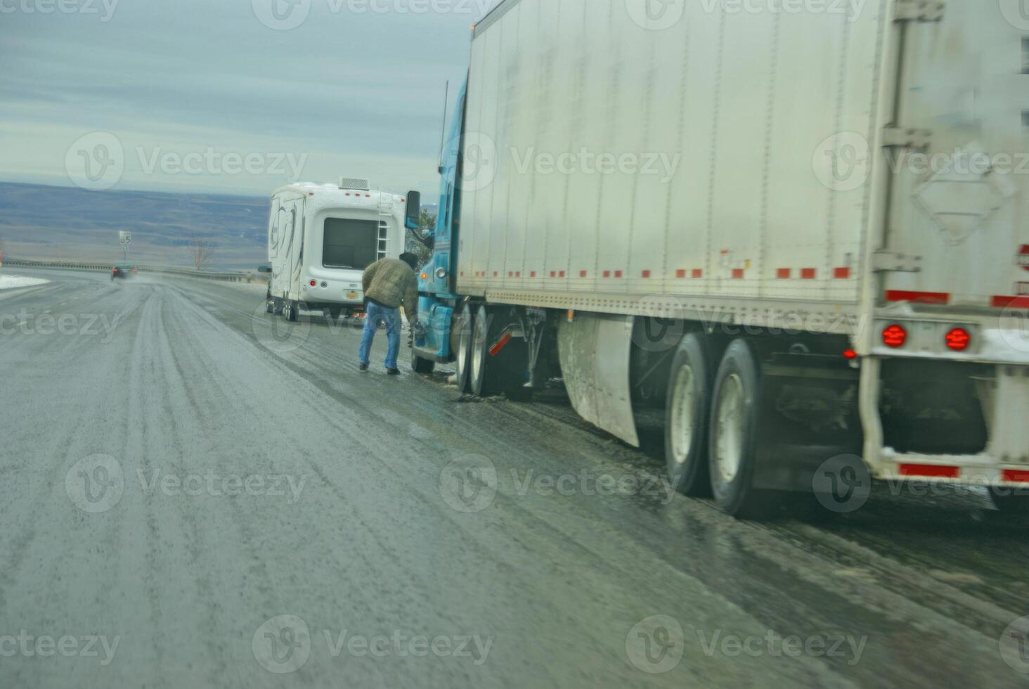 Trucks stop to remove chains photo