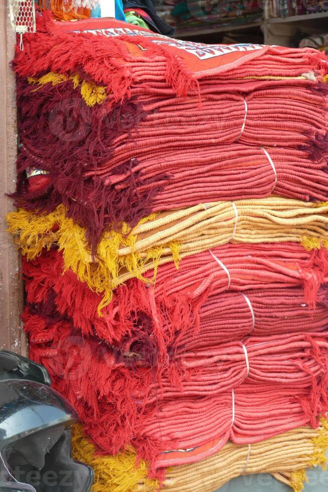 Stacks of red and yellow fabrics at the Ghanta Ghar photo