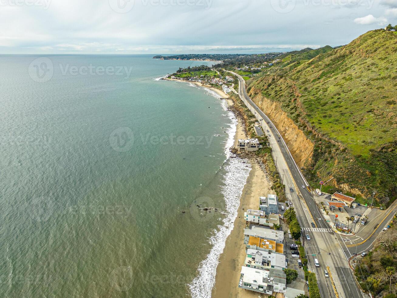 Highway Route 1 California. Aerial Panorama of the coastline and road. Green hills and beach on side photo