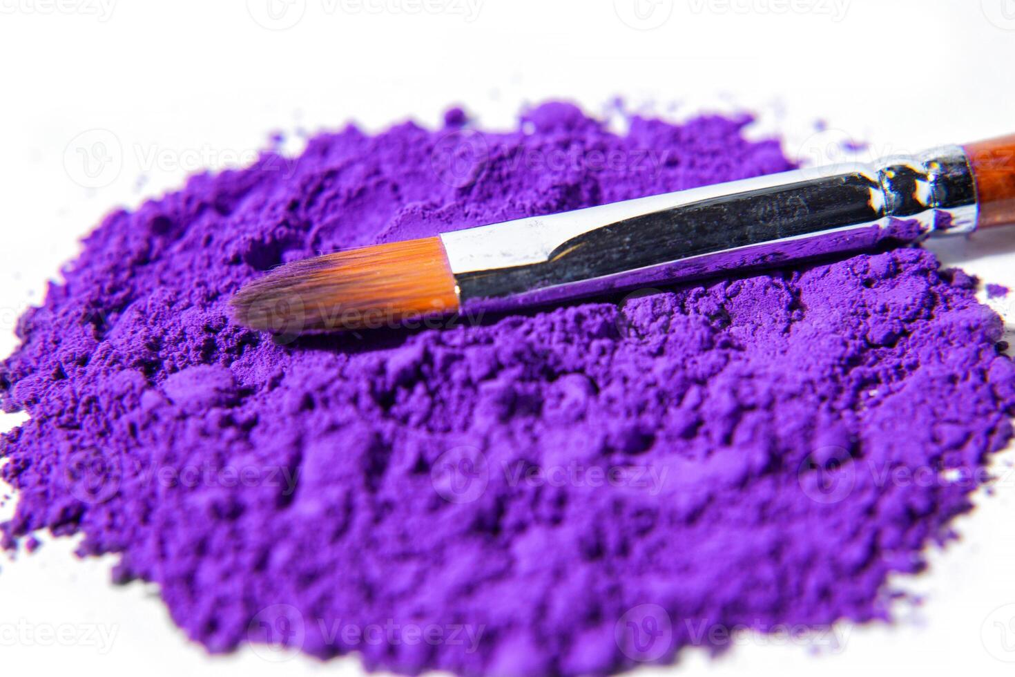 a bunch of dry natural purple pigment on a white background macro photo