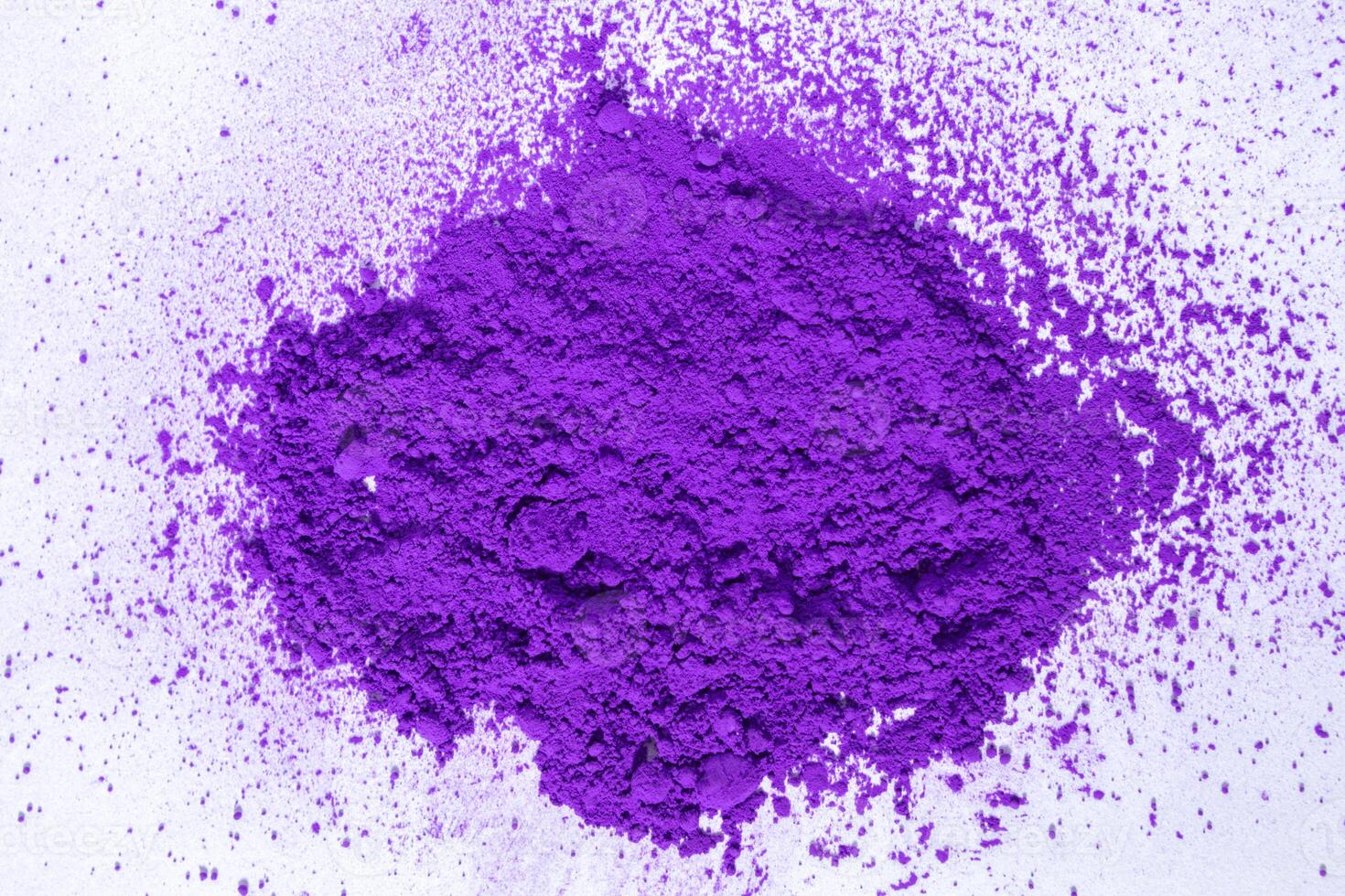 a bunch of dry natural purple pigment on a white background macro photo