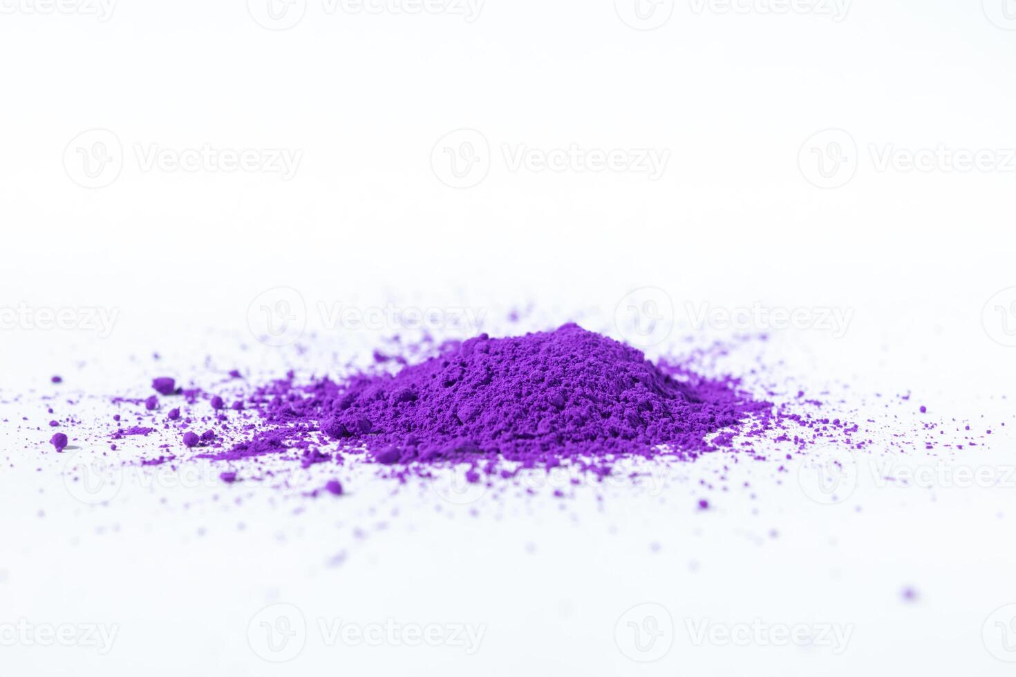 a bunch of dry natural purple pigment on a white background macro photo