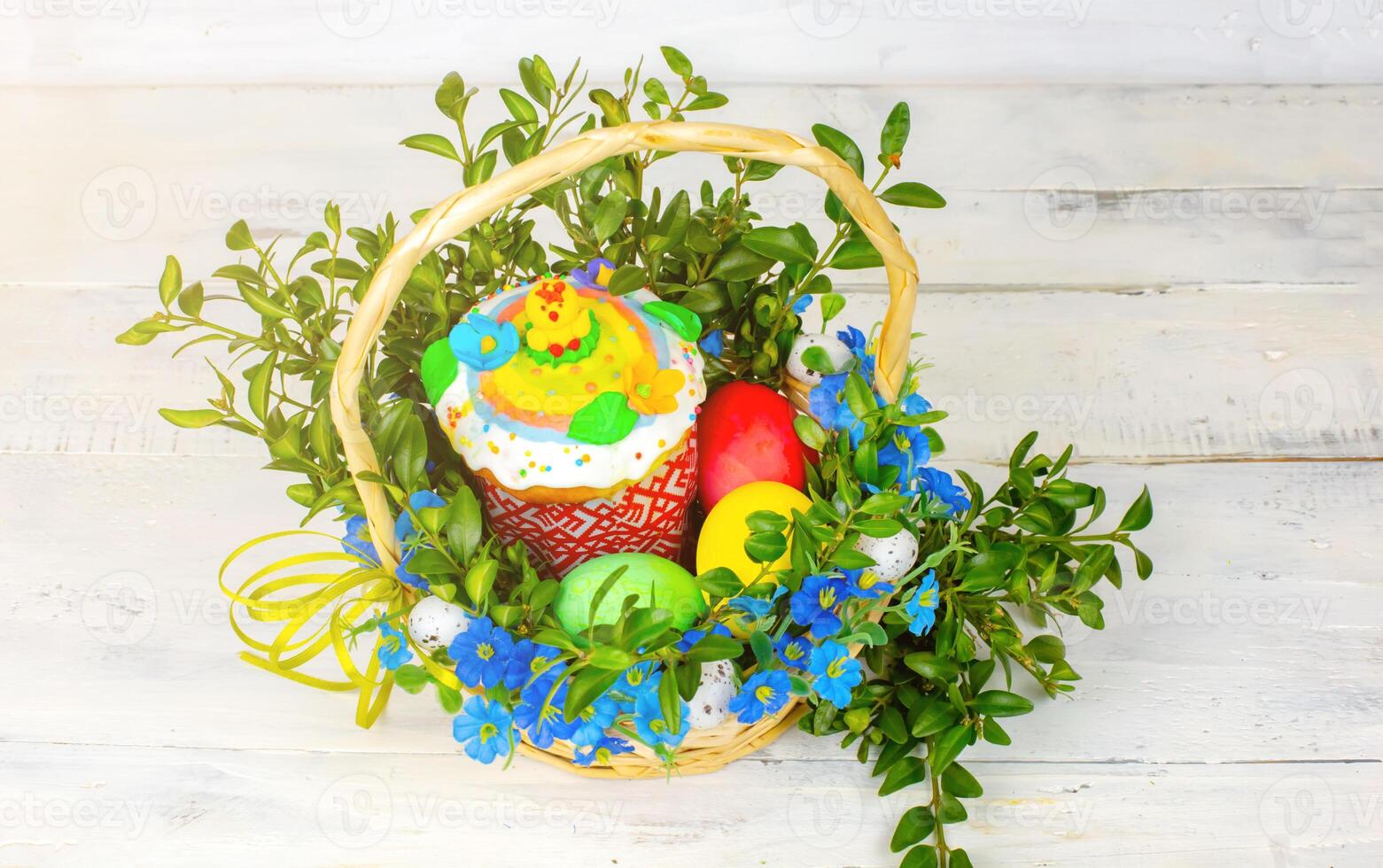 Easter cake and painted eggs, white flowers, festive composition in rustic style,ukrainian orthodox tradition, vintage wooden background, selective focus photo