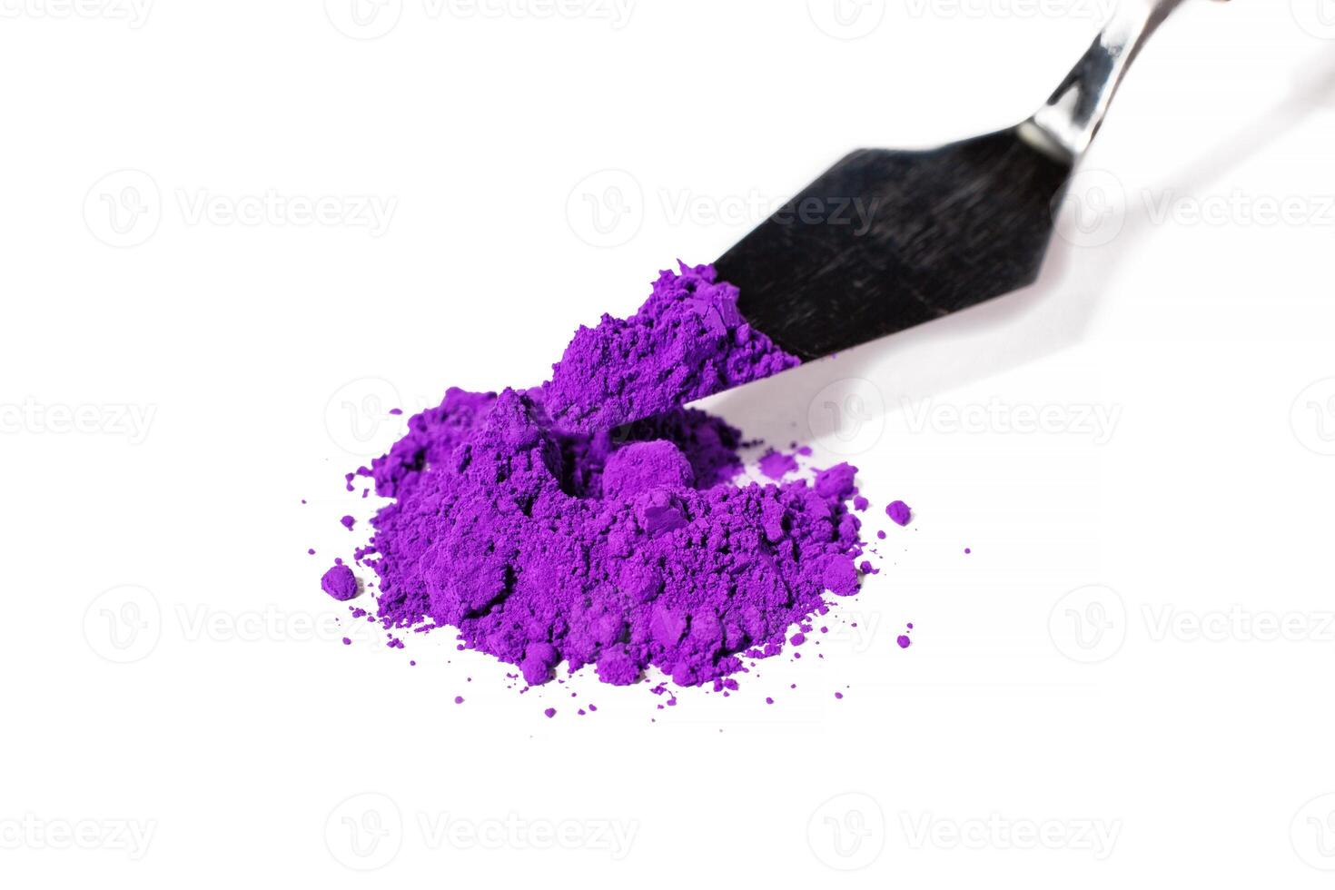 a bunch of dry natural purple pigment on a white background macro photo