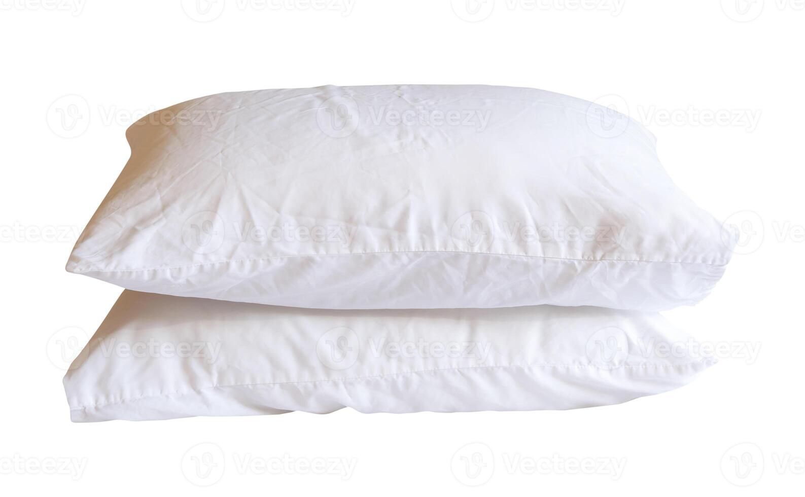 Side view of two white pillows in stack after use in hotel or resort room isolated on white background with clipping path photo