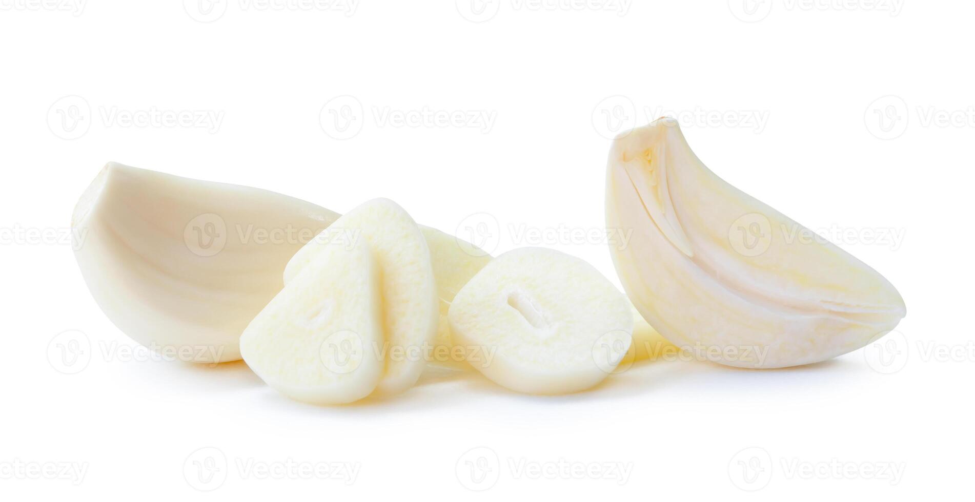 Front view of fresh white garlic cloves with half and slices in stack isolated on white background with clipping path photo