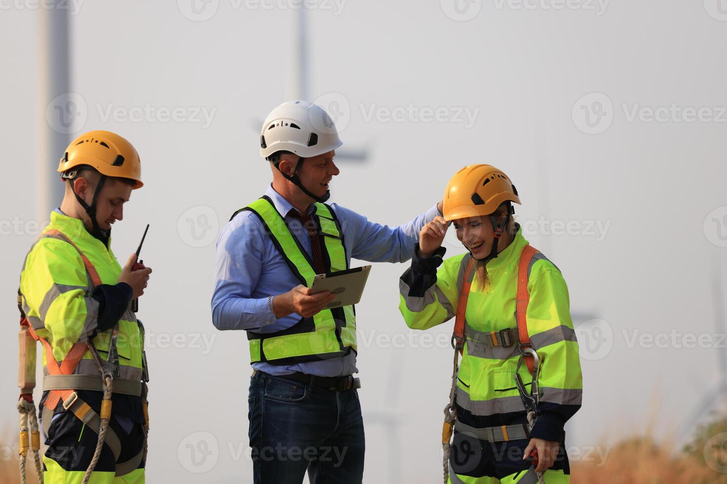 Specialist wind turbine Team of Engineers discussing Green Energy Production in Wind Turbines Farm or Windmills Field. Team of Engineer Energy Planning Activity in Windmills Industrial Area photo