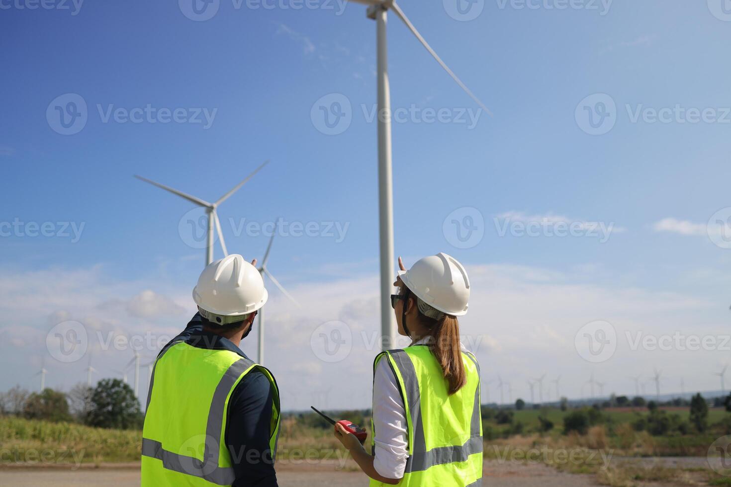 A couple of Electric engineers working together at a wind turbine farm. photo