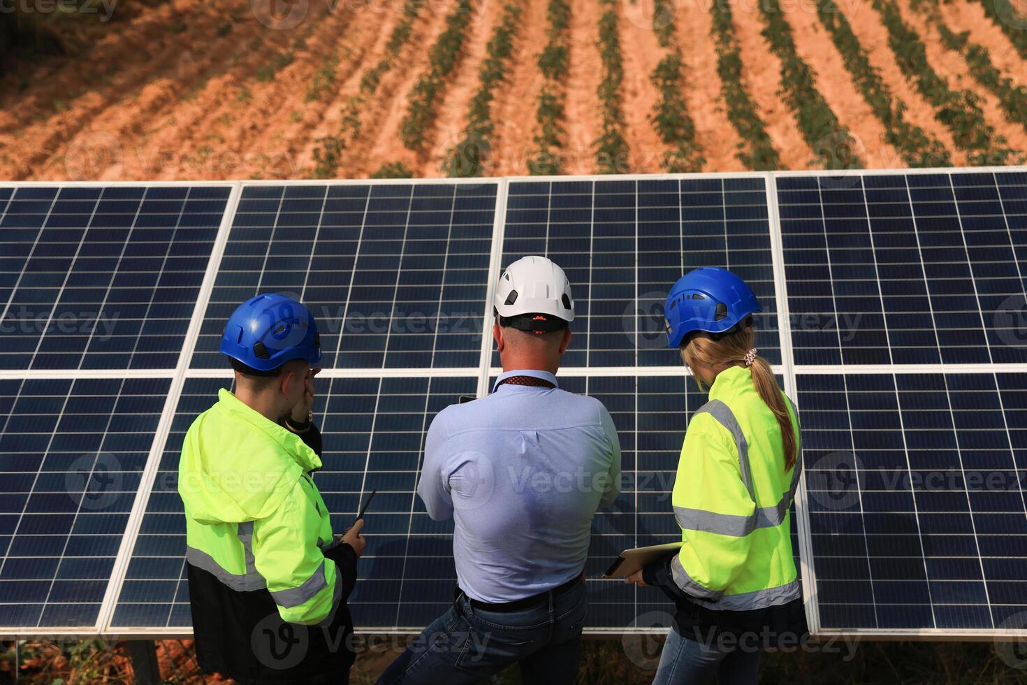 The engineering designer had a discussion with his teamwork at solar panels about the prototype of the solar cell at the field photo