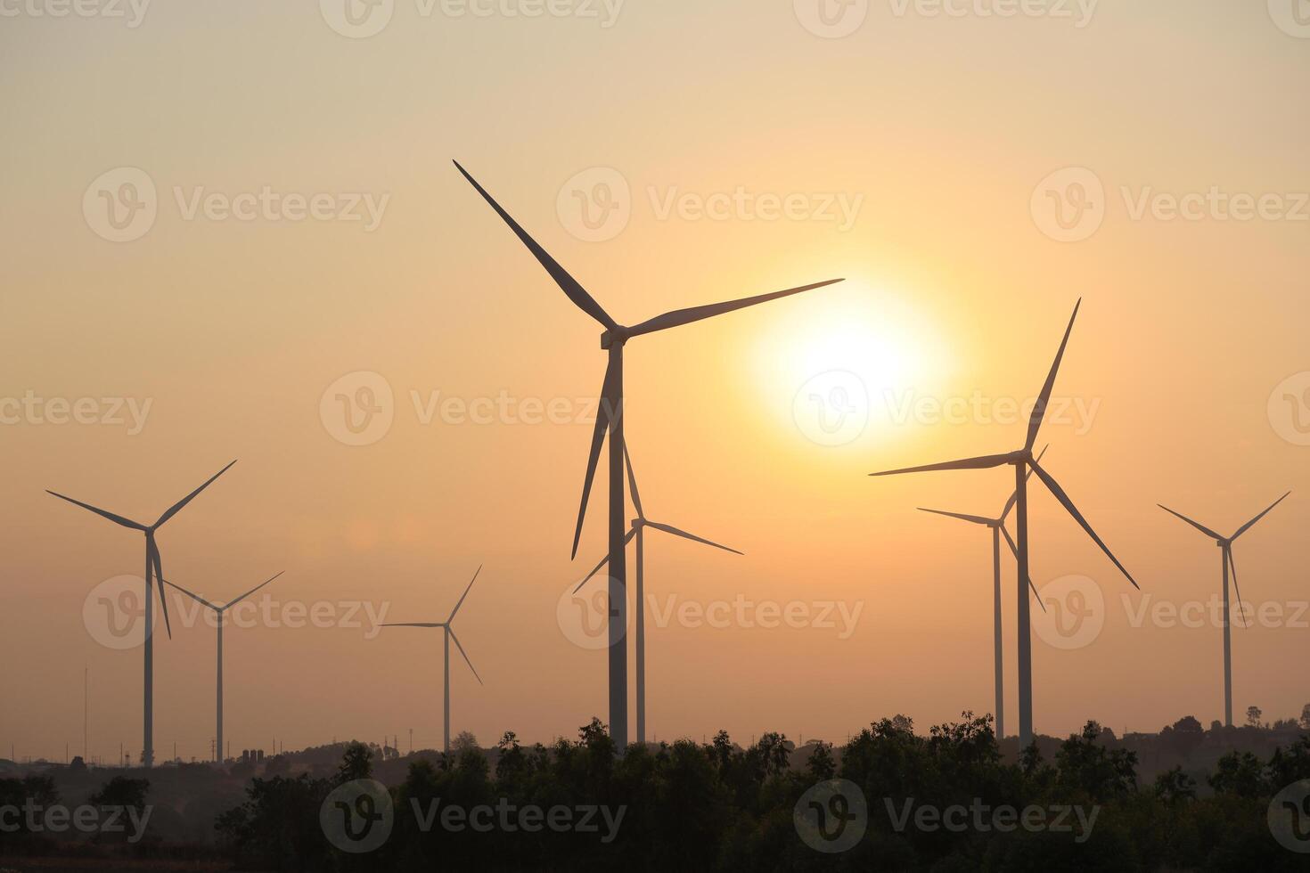 Silhouette Windmill farm generates green energy, a sustainable energy alternative to fossil fuels, fights climate change and global warming with green alternative energy, wind power photo