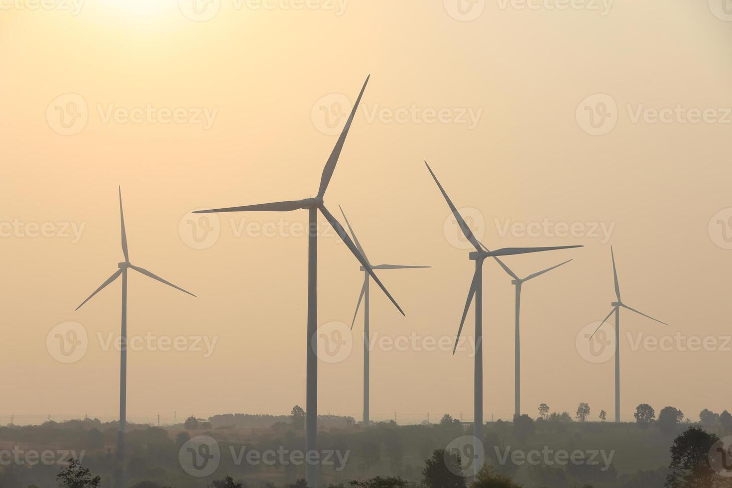 Silhouette Windmill farm generates green energy, a sustainable energy alternative to fossil fuels, fights climate change and global warming with green alternative energy, wind power photo