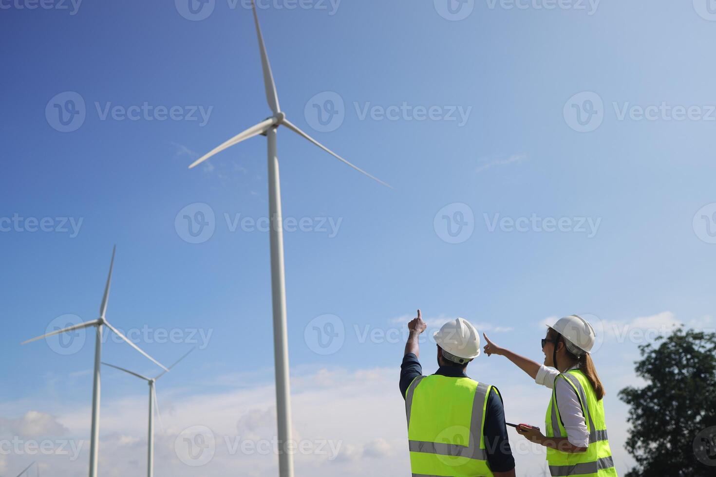 A couple of Electric engineers working together at a wind turbine farm. photo