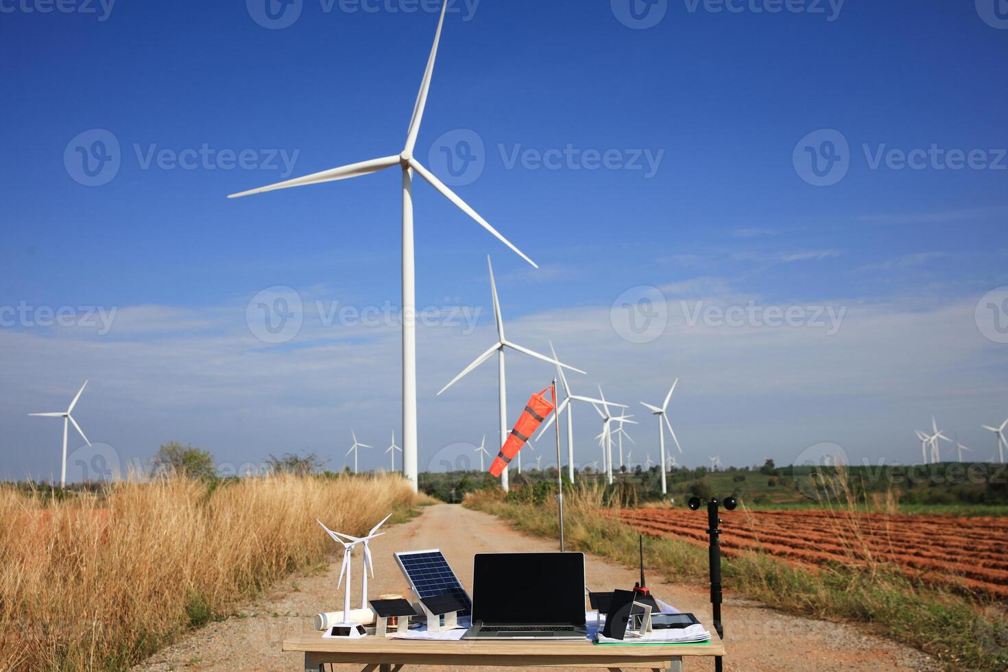 Wind turbines Solar Cell model with wind measurement equipment on table in front of huge wind turbine, Wind turbine engineer research concept photo