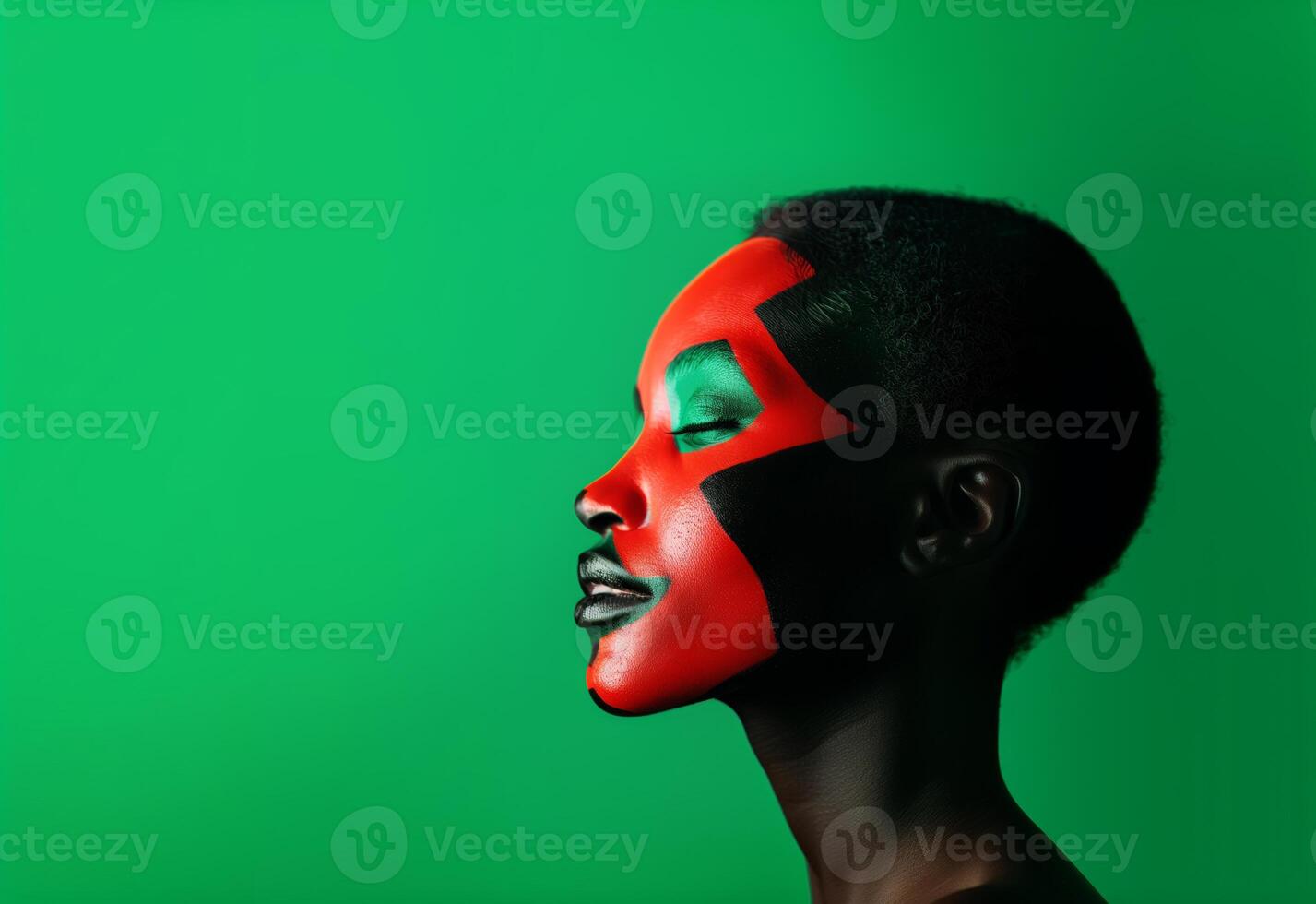 African American young woman with her face skin painted in red, black and green colors. Black history copy space background. photo