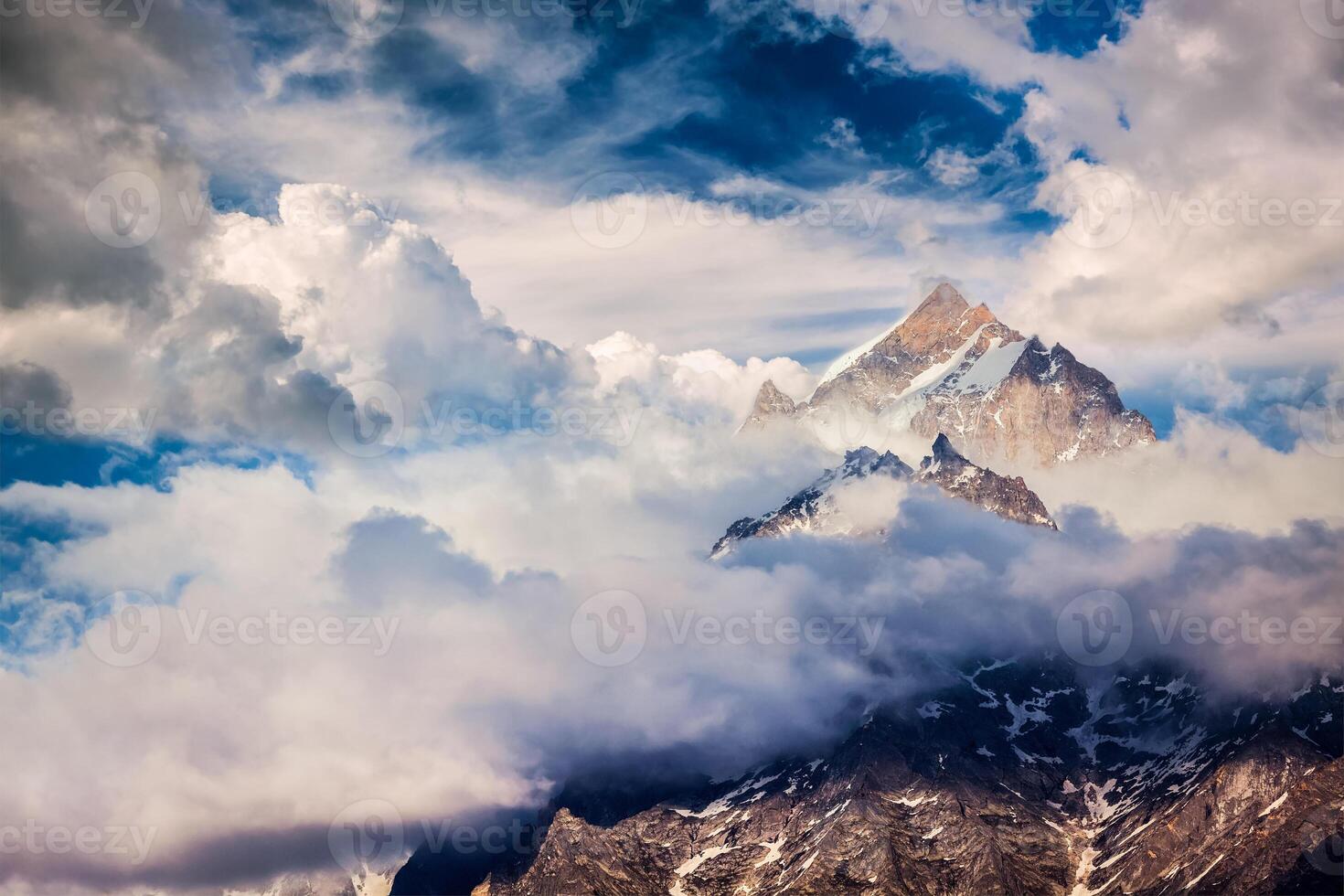 Snowcapped summit top of mountain in Himalayas photo
