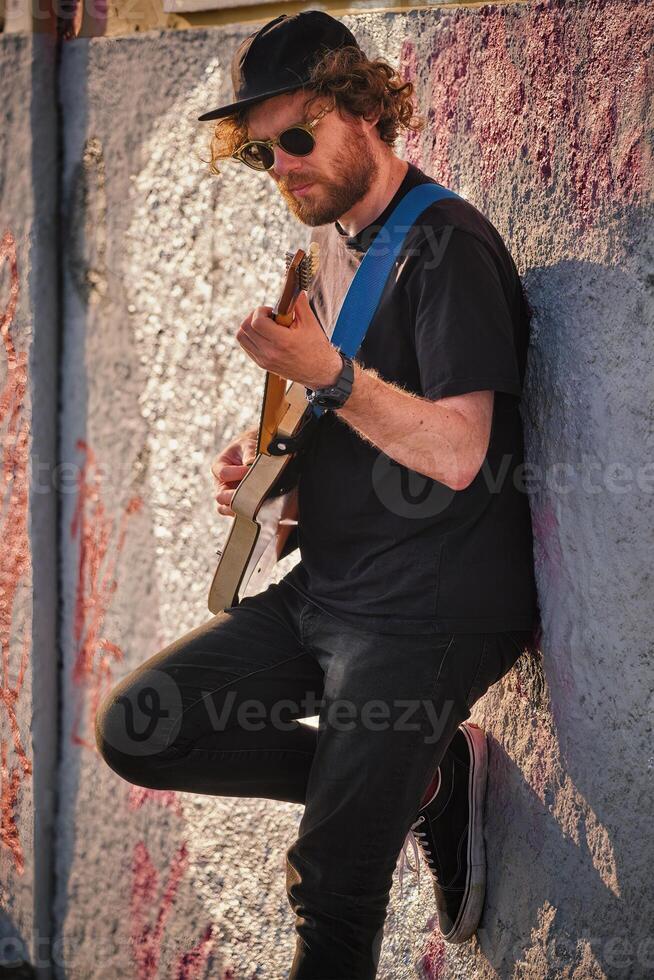 Street musician playing electric guitar in the street photo
