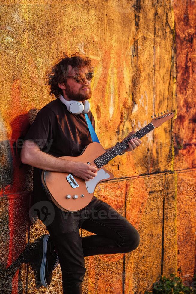 Street musician playing electric guitar in the street photo