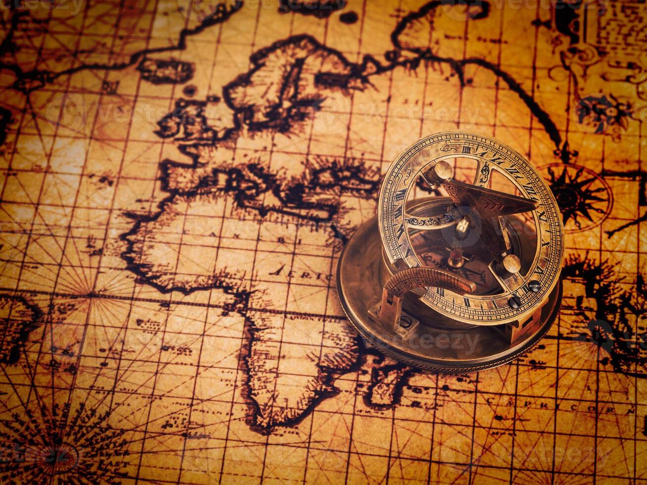 Old vintage compass on ancient map photo