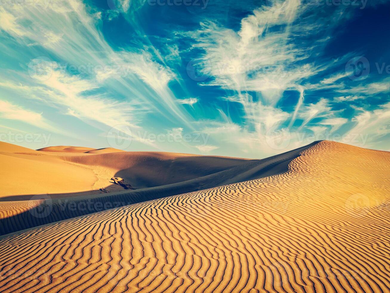 Sand dunes in desert photo