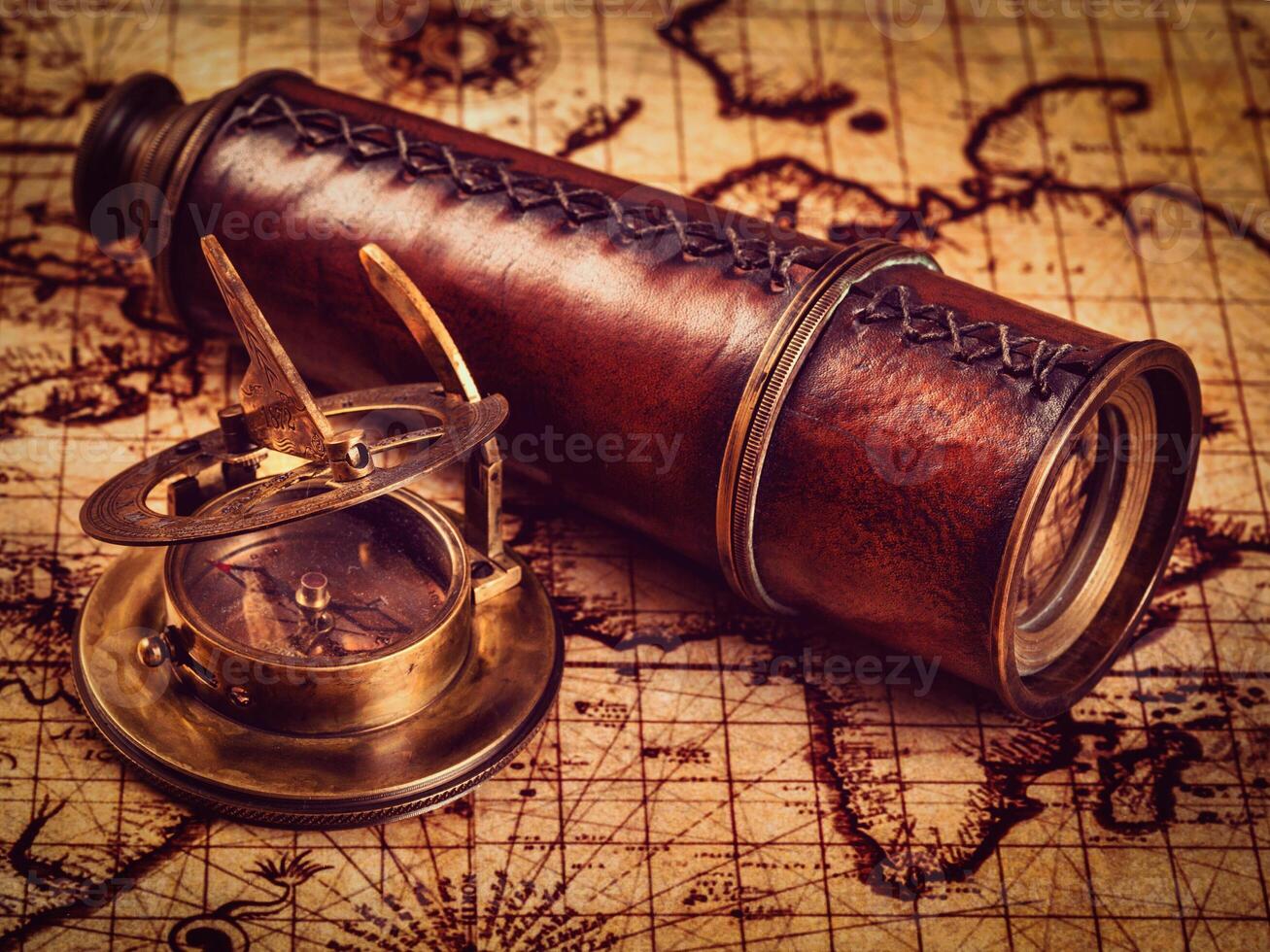Old vintage compass on ancient map photo