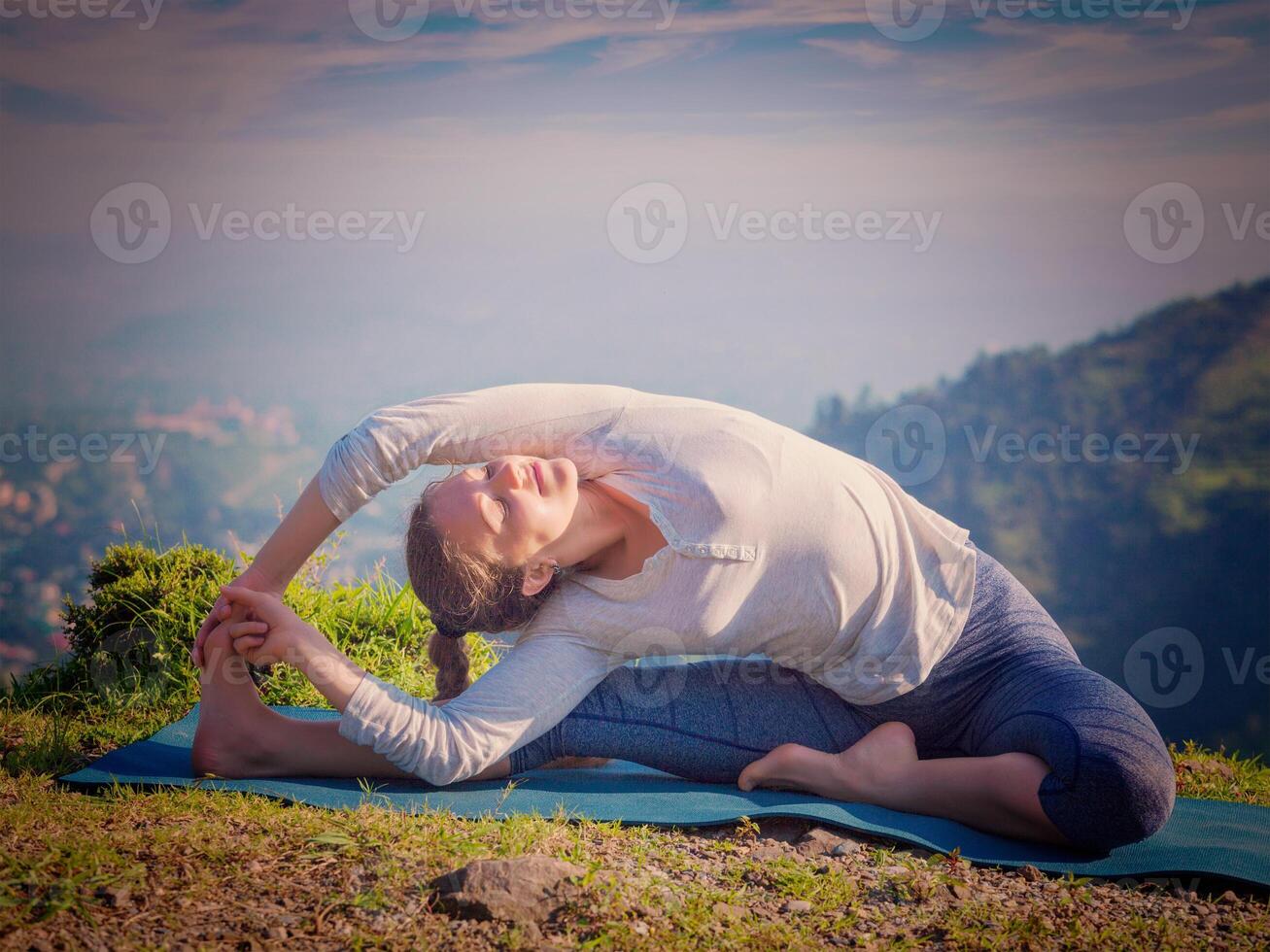 Young sporty fit woman doing Hatha Yoga asana photo