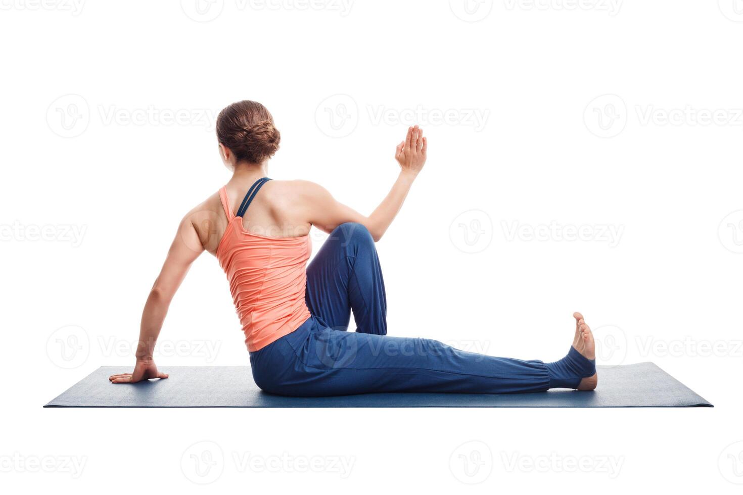woman practices yoga asana Marichyasana C photo