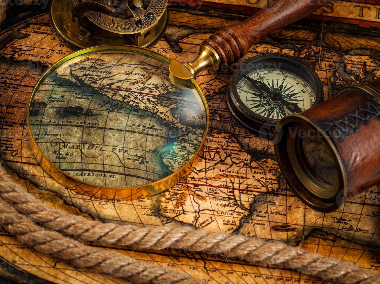Old vintage compass and navigation instruments on ancient map photo