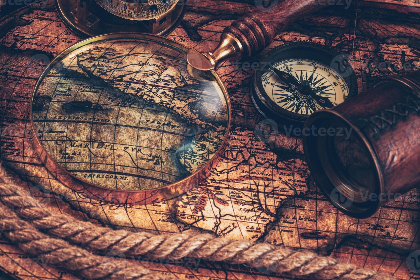 Old vintage compass on ancient map photo