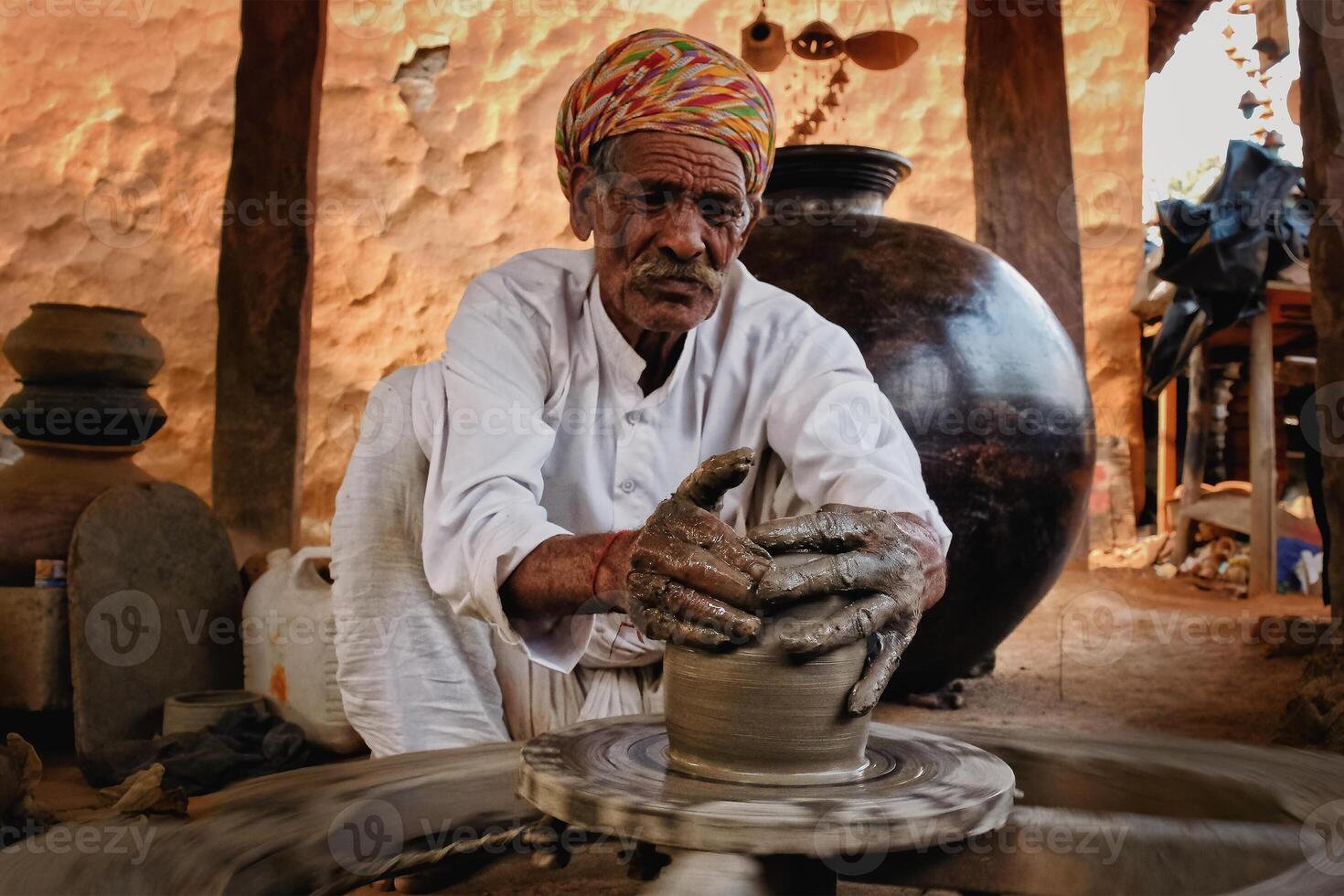 Indian potter at work. Handwork craft from Shilpagram, Udaipur, Rajasthan, India photo