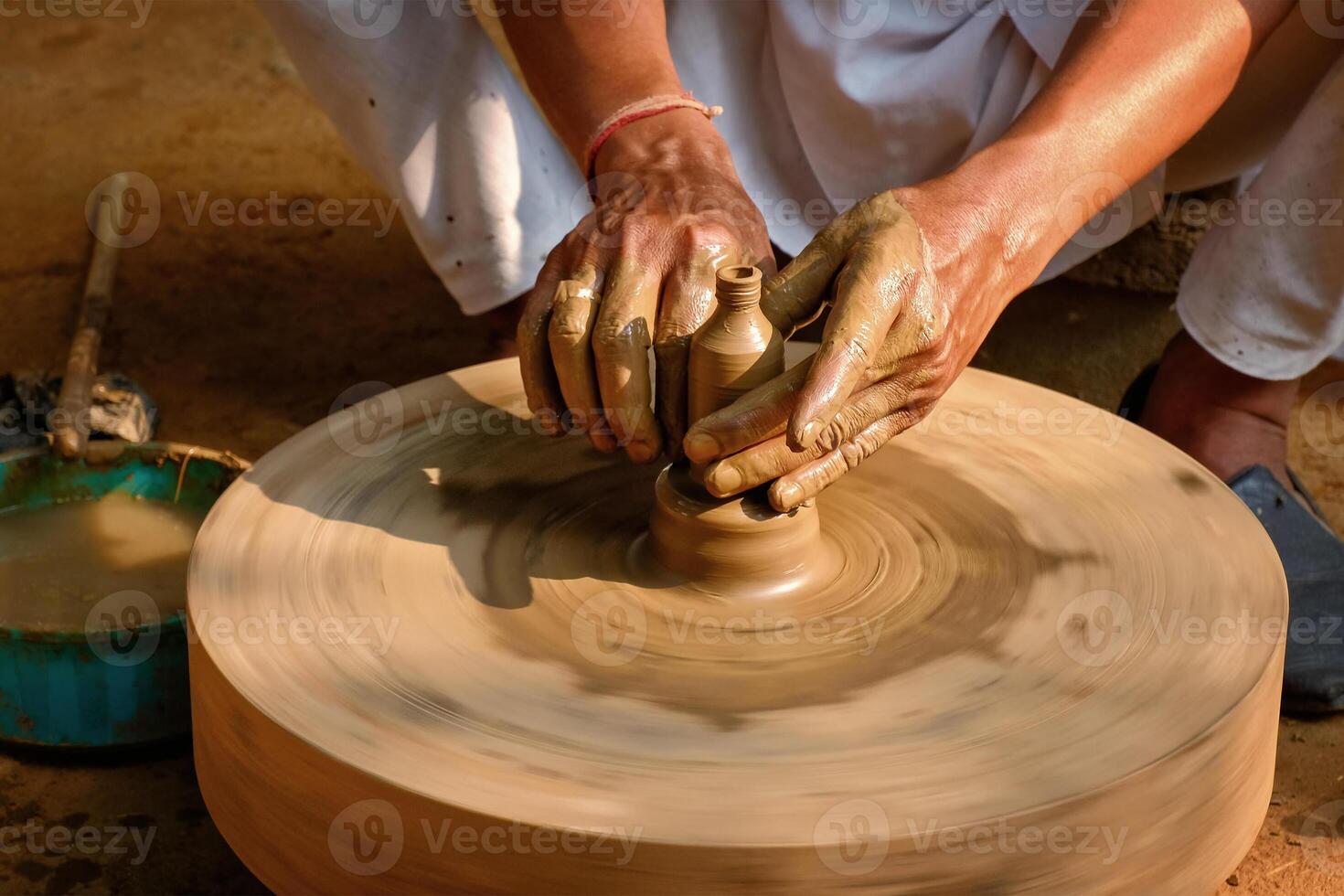 Indian potter hands at work, Shilpagram, Udaipur, Rajasthan, India photo