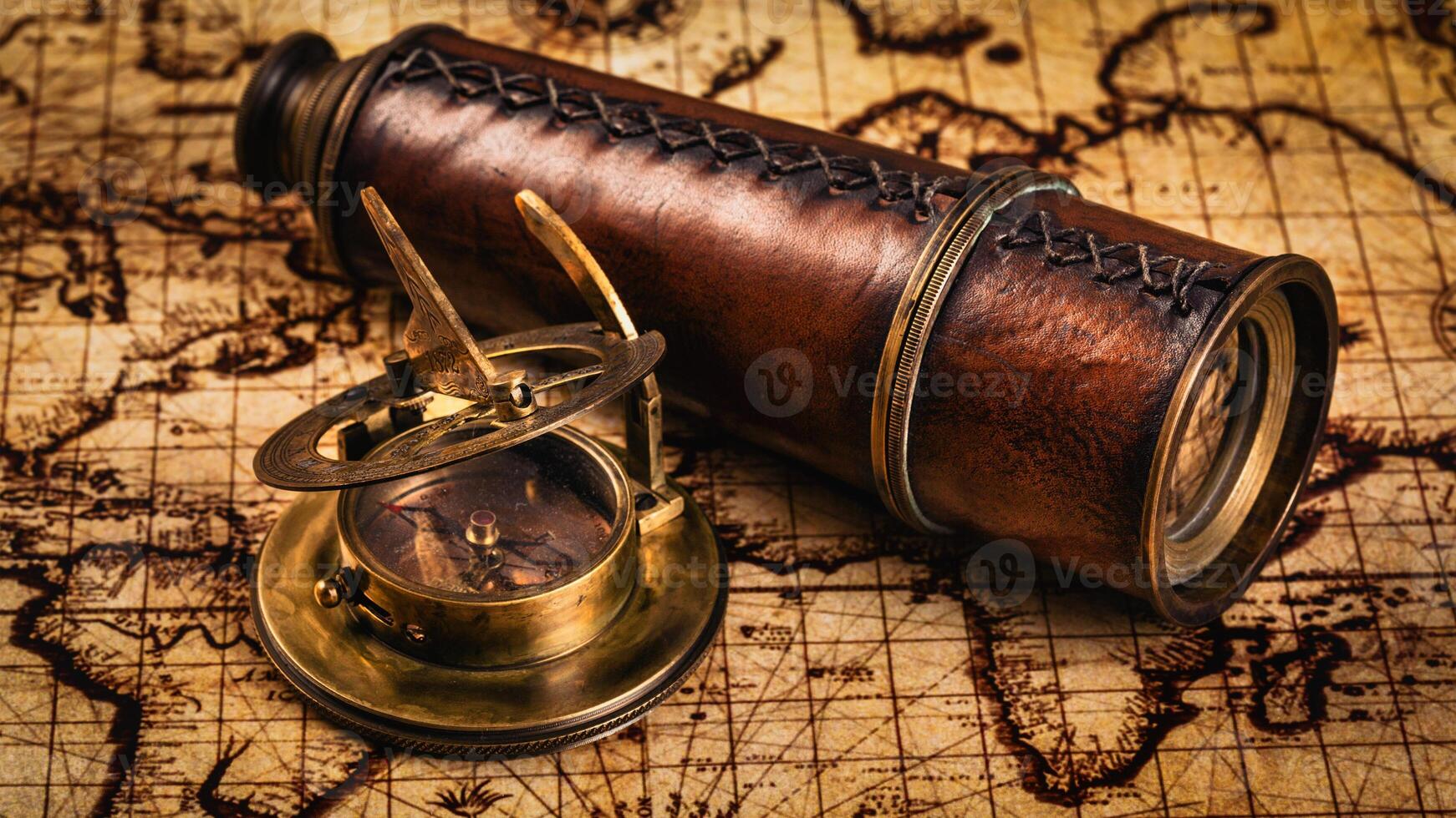 Old vintage compass on ancient map photo