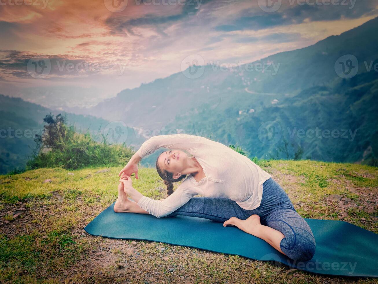 Young sporty fit woman doing Hatha Yoga asana photo