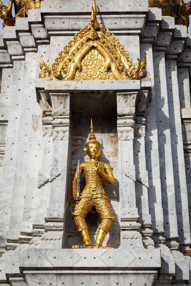 Gold guard on tower, Wat Phi, Thailand photo