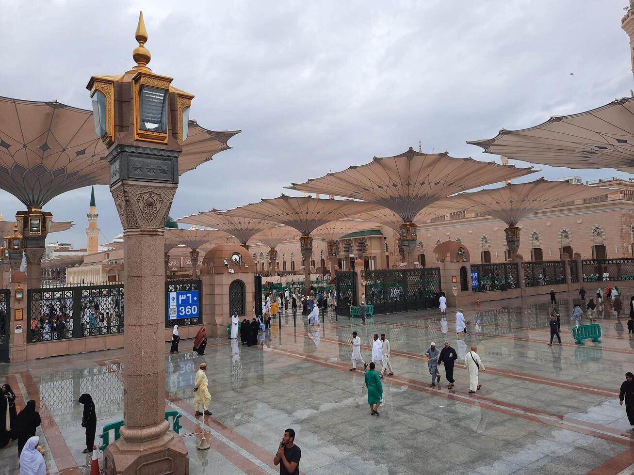 Madinah, Saudi Arabia, 29 March 2024 - Beautiful daytime outdoor view of Prophet's Mosque Madinah in dark clouds and rain. photo
