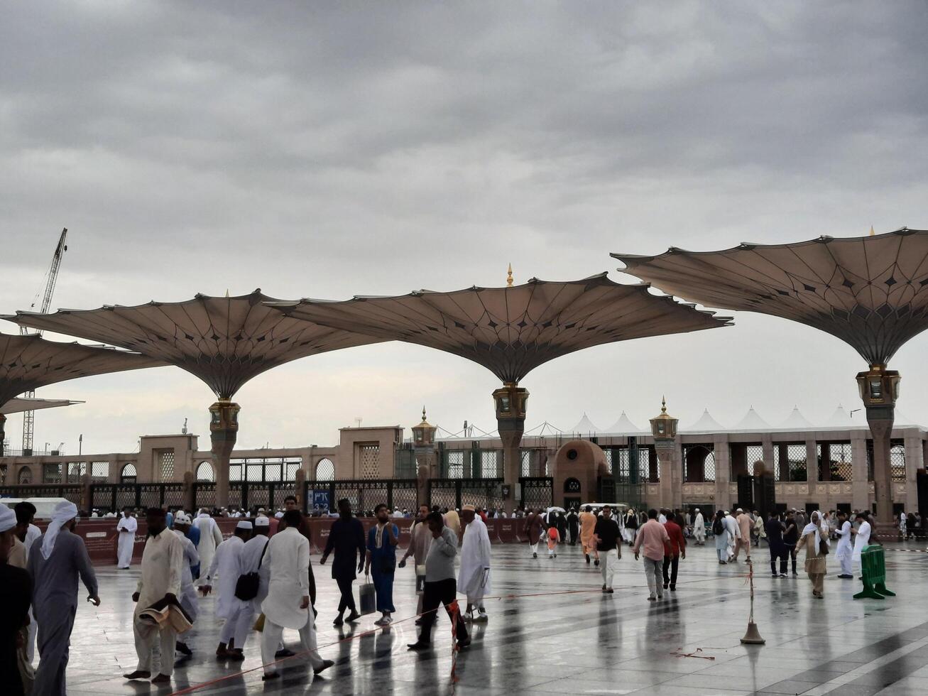 Madinah, Saudi Arabia, 29 March 2024 - Beautiful daytime outdoor view of Prophet's Mosque Madinah in dark clouds and rain. photo
