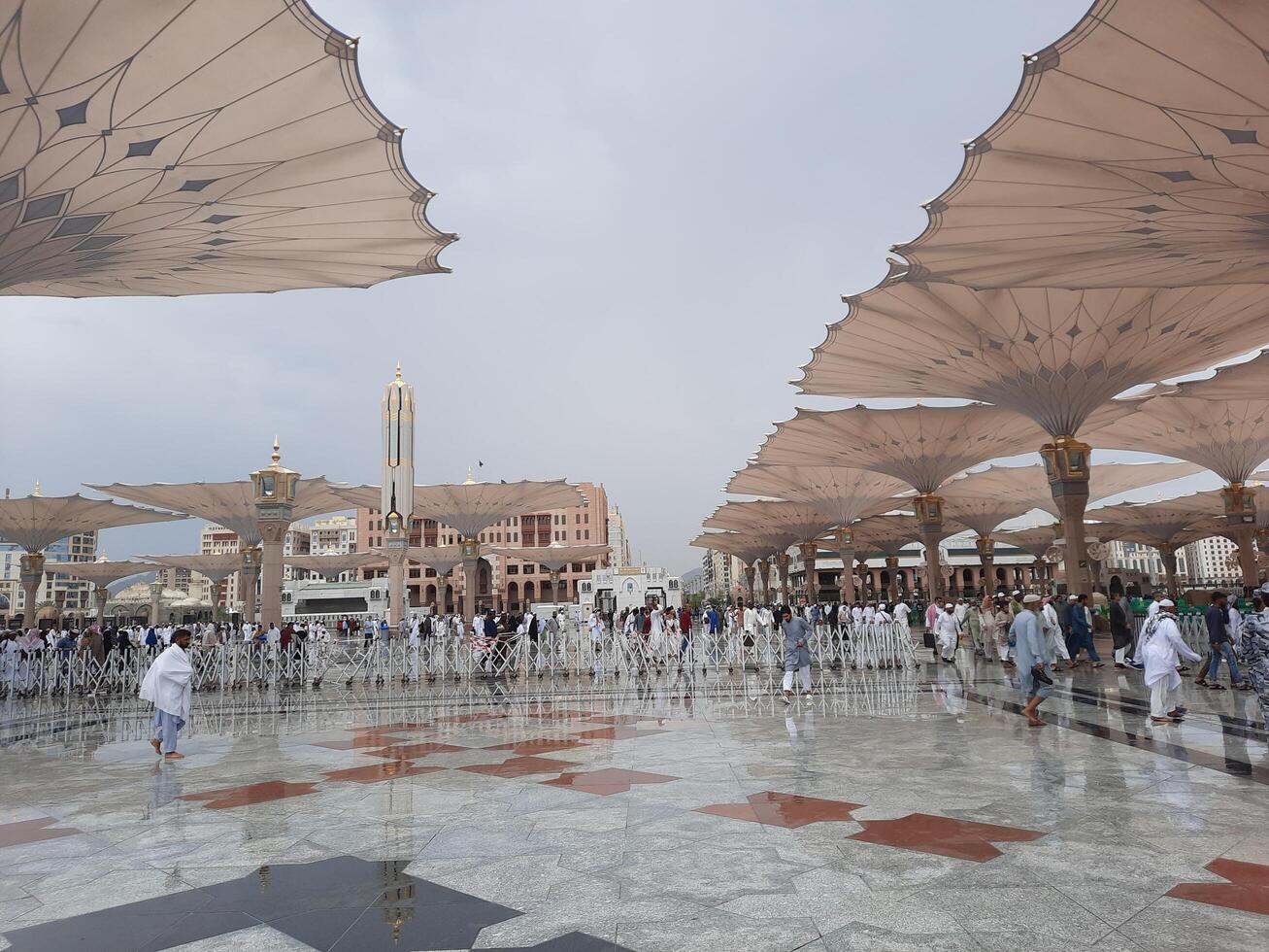 Madinah, Saudi Arabia, 29 March 2024 - Beautiful daytime outdoor view of Prophet's Mosque Madinah in dark clouds and rain. photo