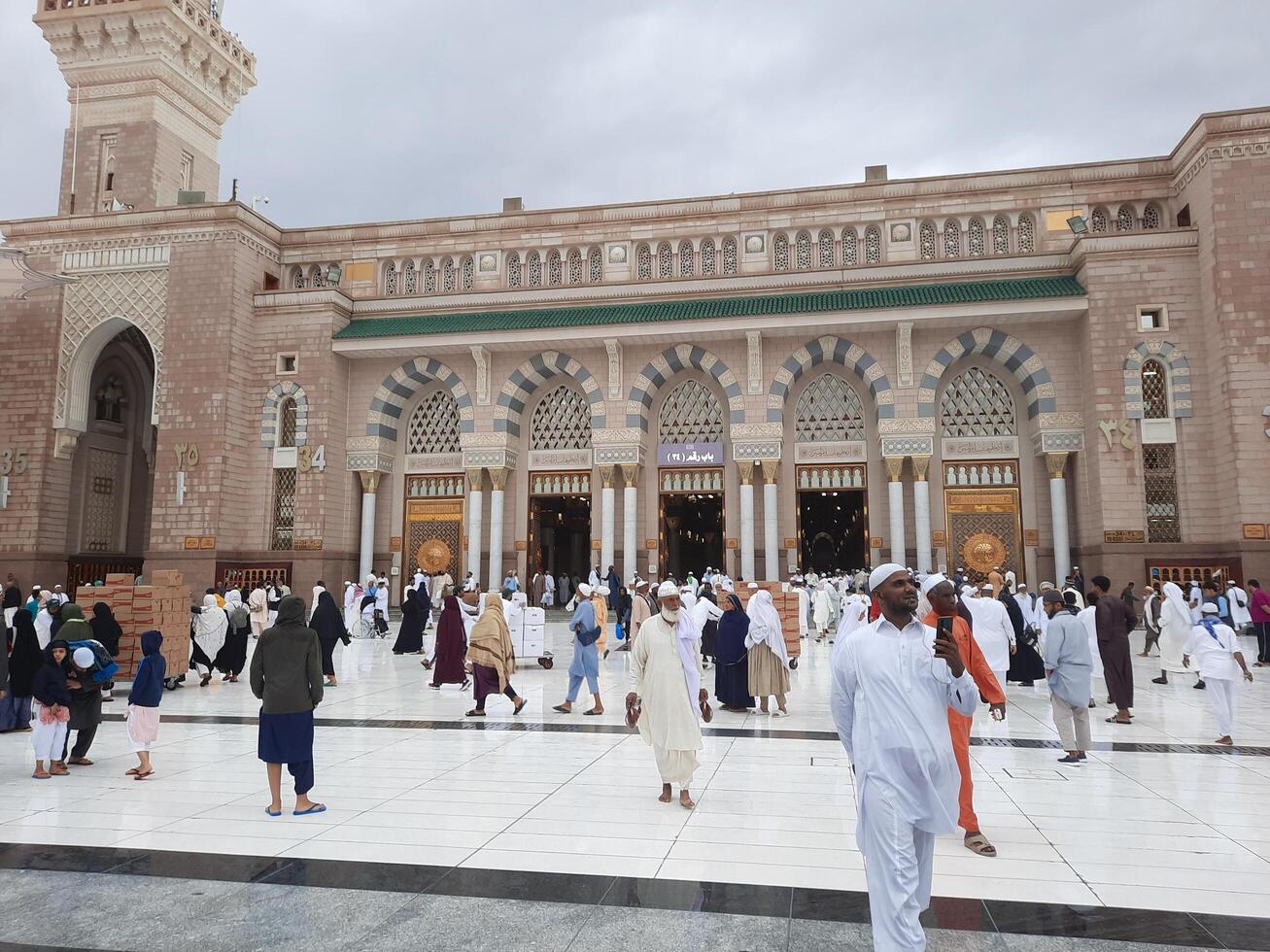 Madinah, Saudi Arabia, 29 March 2024 - Beautiful daytime outdoor view of Prophet's Mosque Madinah in dark clouds and rain. photo