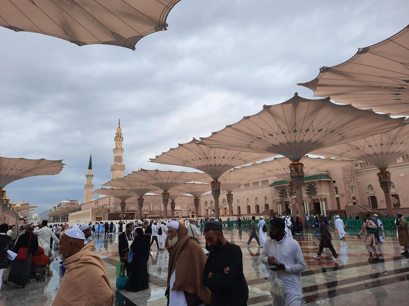 Madinah, Saudi Arabia, 29 March 2024 - Beautiful daytime outdoor view of Prophet's Mosque Madinah in dark clouds and rain. photo