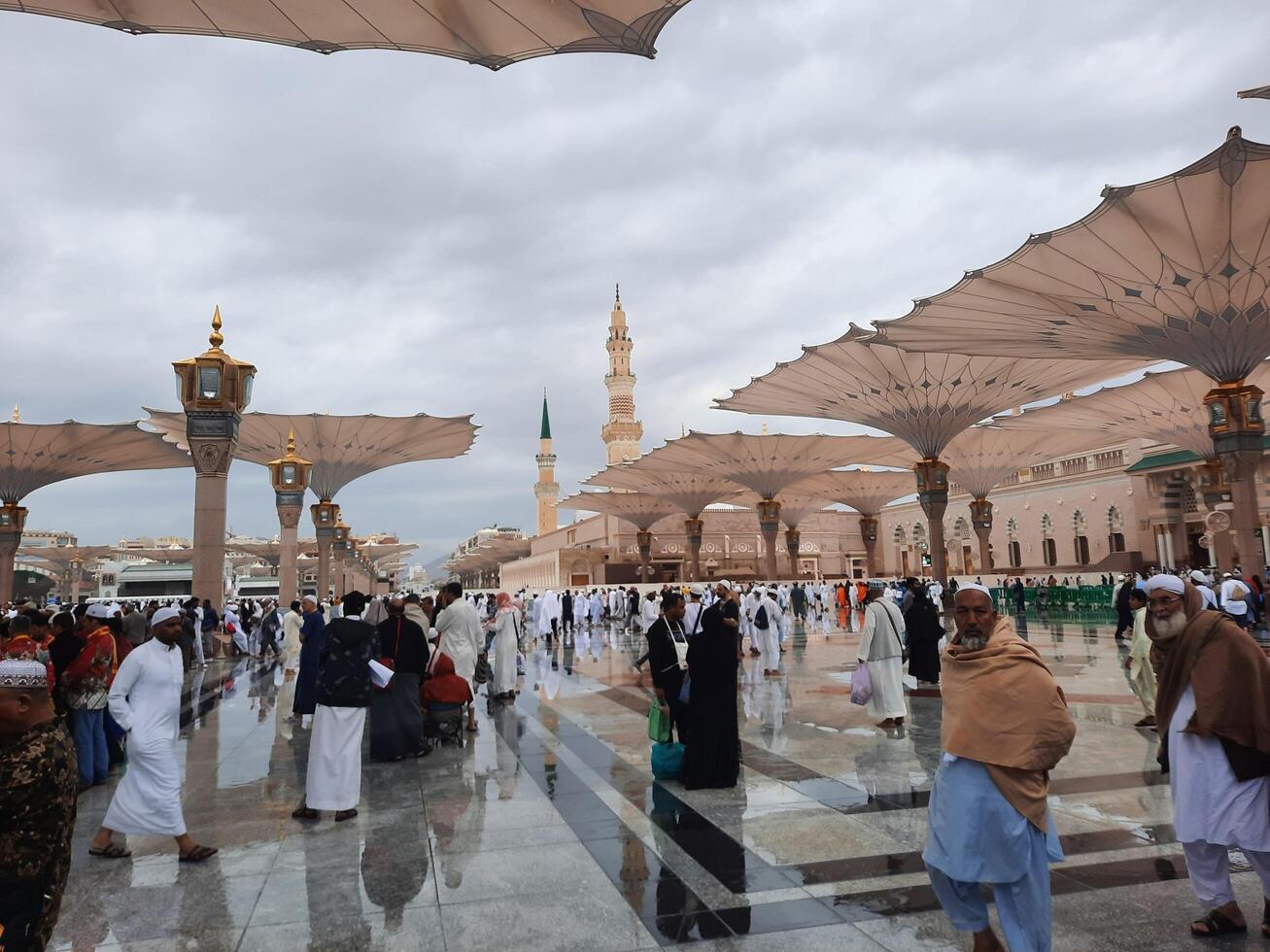 Madinah, Saudi Arabia, 29 March 2024 - Beautiful daytime outdoor view of Prophet's Mosque Madinah in dark clouds and rain. photo
