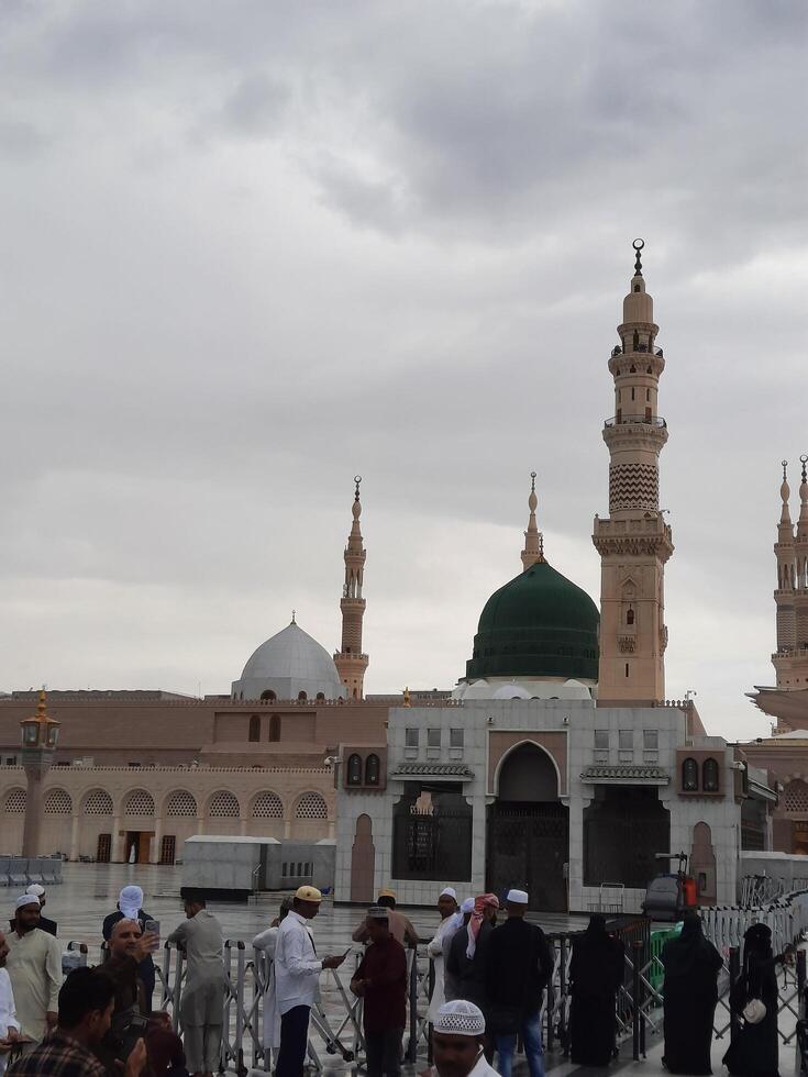 Madinah, Saudi Arabia, 29 March 2024 - Beautiful daytime outdoor view of Prophet's Mosque Madinah in dark clouds and rain. photo
