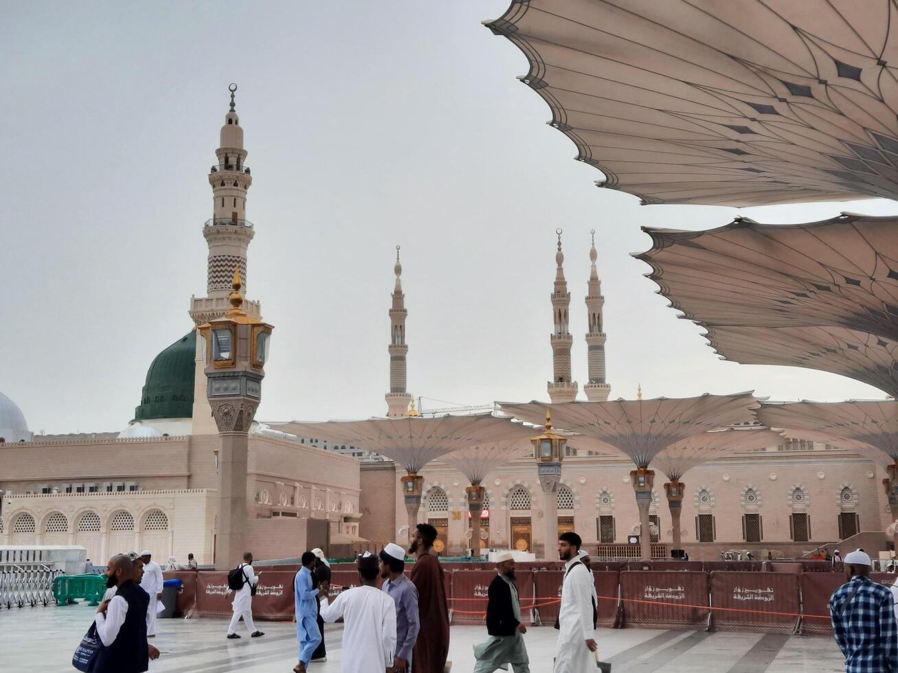 Madinah, Saudi Arabia, 29 March 2024 - Beautiful daytime outdoor view of Prophet's Mosque Madinah in dark clouds and rain. photo