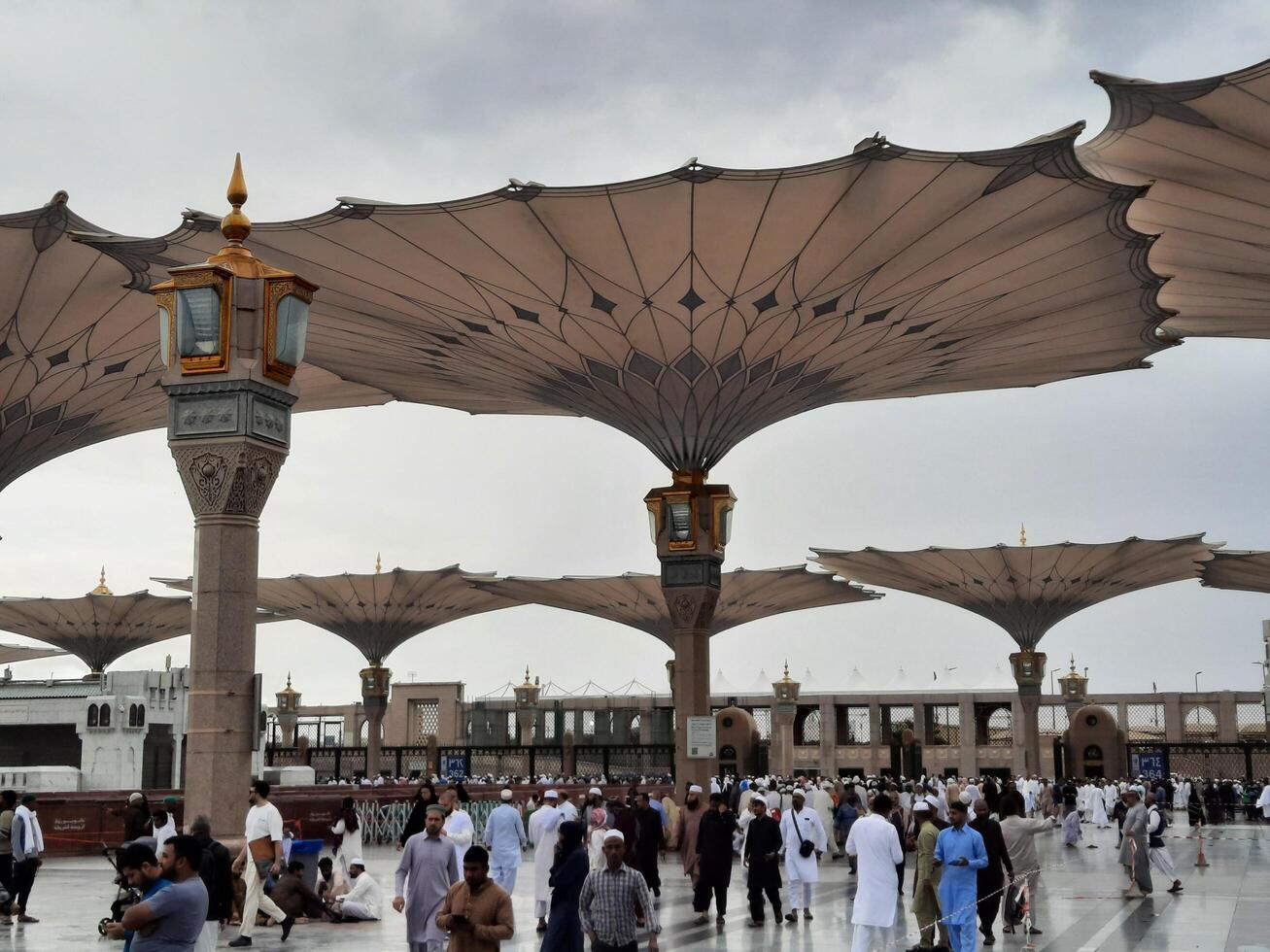 Madinah, Saudi Arabia, 29 March 2024 - Beautiful daytime outdoor view of Prophet's Mosque Madinah in dark clouds and rain. photo