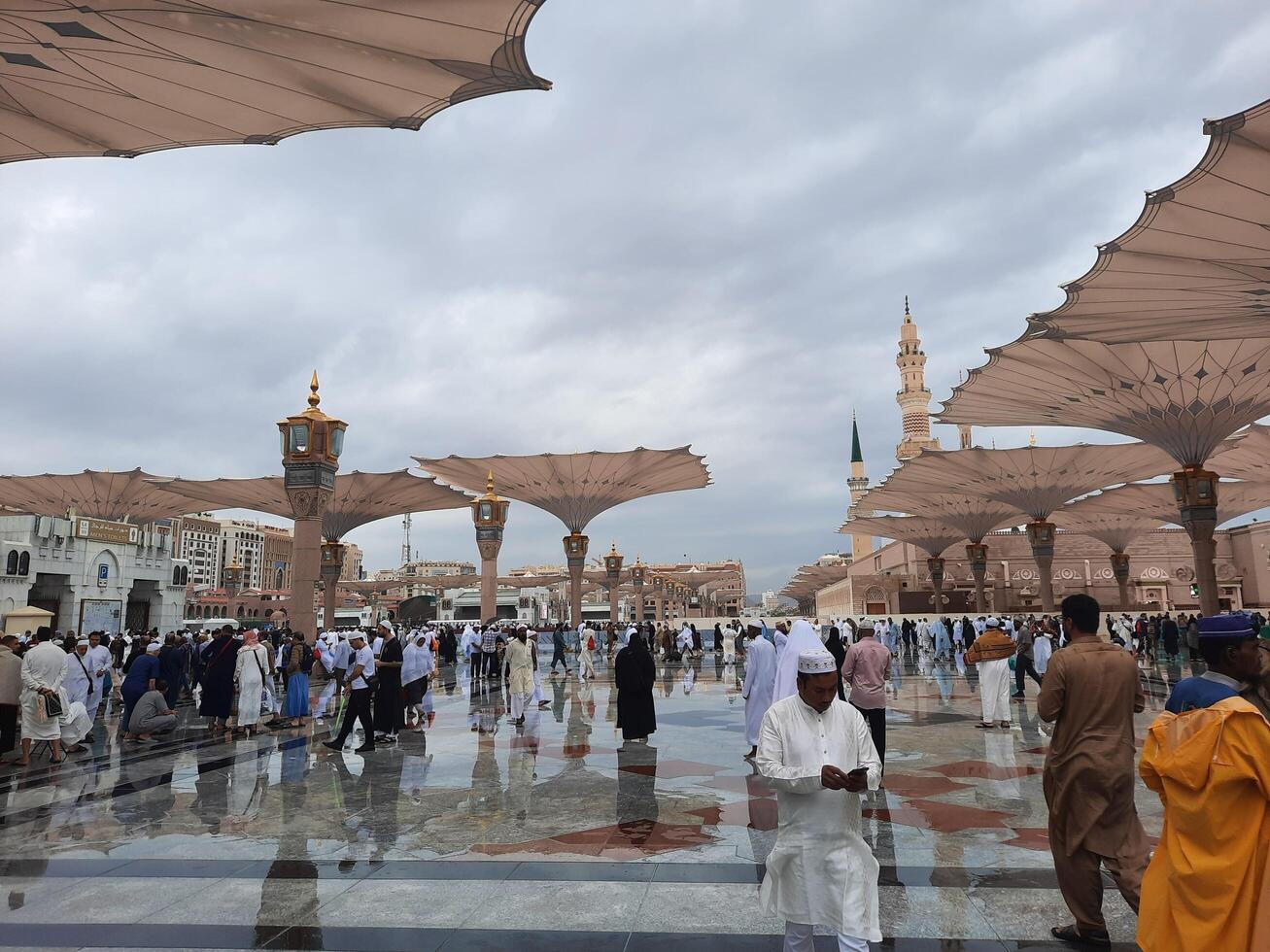 Madinah, Saudi Arabia, 29 March 2024 - Beautiful daytime outdoor view of Prophet's Mosque Madinah in dark clouds and rain. photo