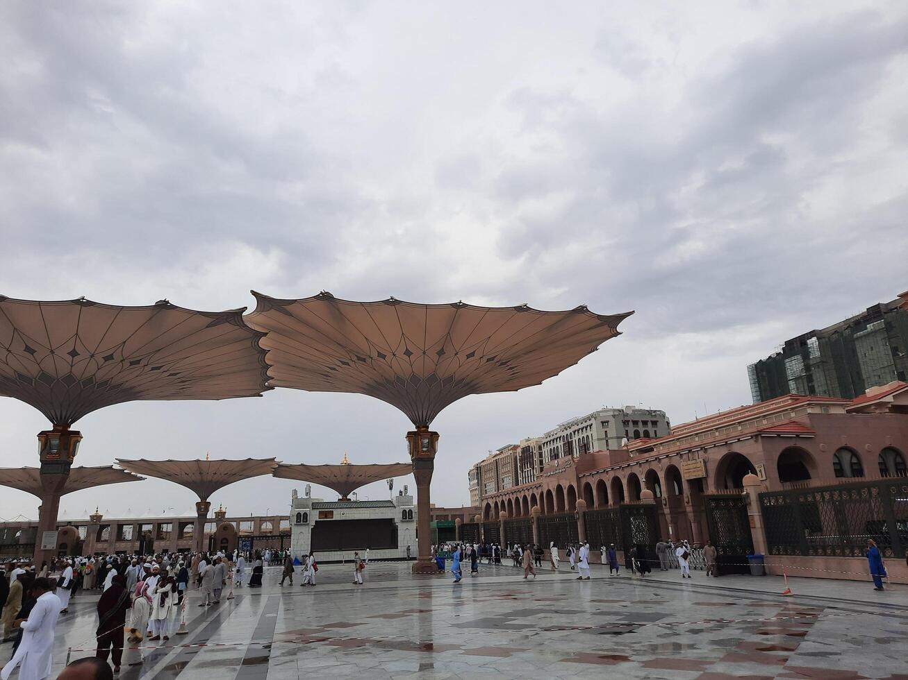 Madinah, Saudi Arabia, 29 March 2024 - Beautiful daytime outdoor view of Prophet's Mosque Madinah in dark clouds and rain. photo