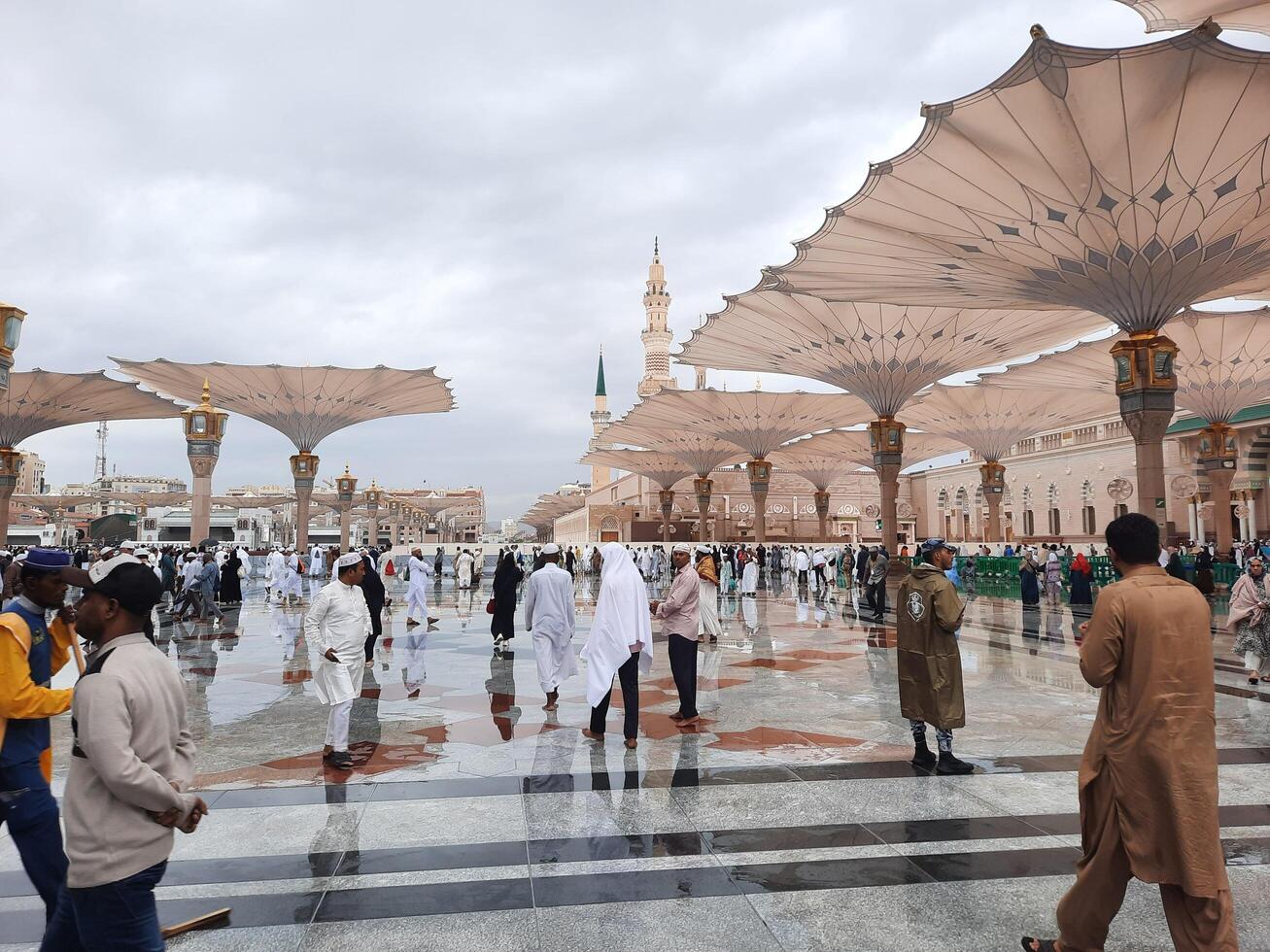 Madinah, Saudi Arabia, 29 March 2024 - Beautiful daytime outdoor view of Prophet's Mosque Madinah in dark clouds and rain. photo