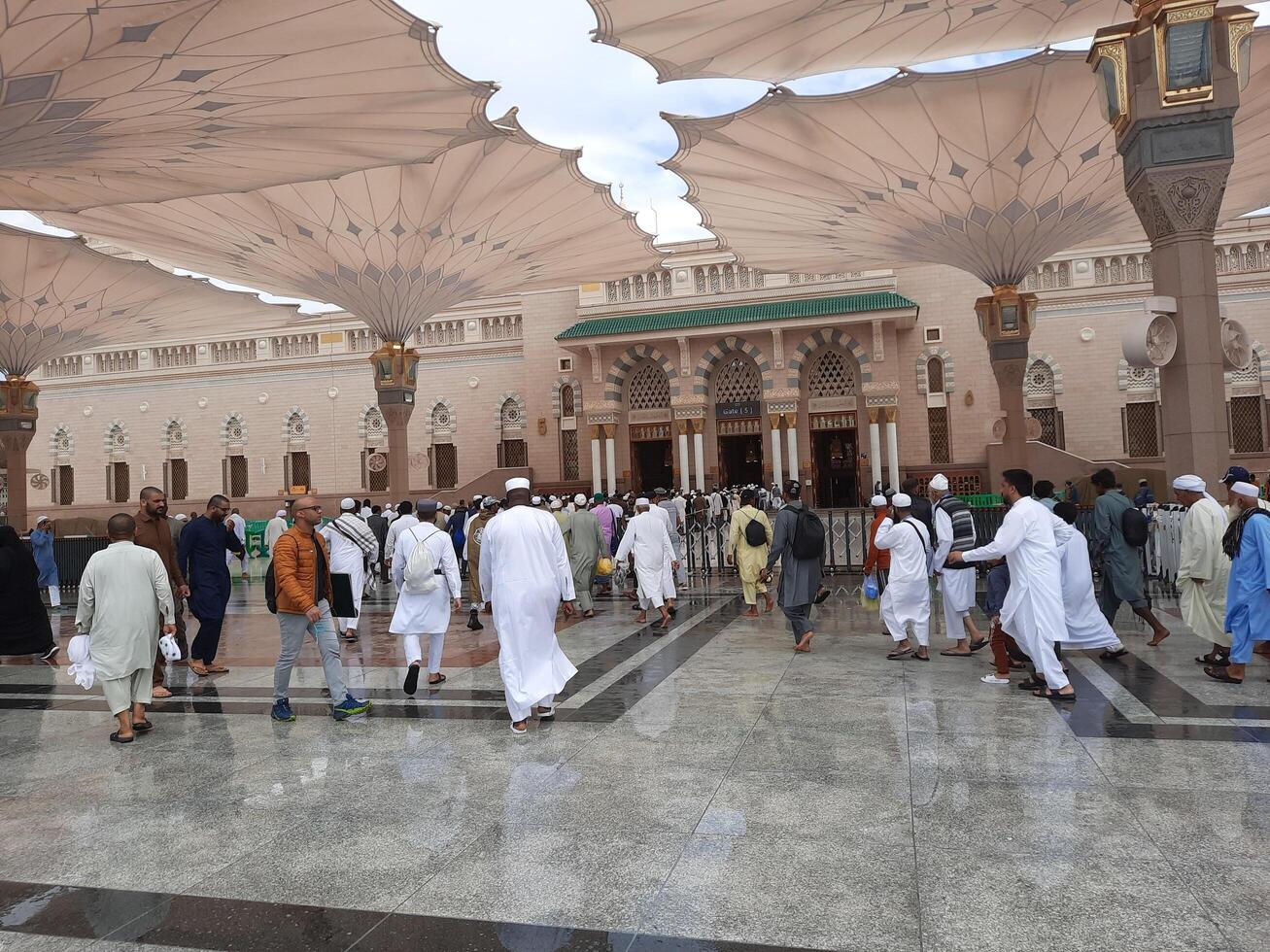 Madinah, Saudi Arabia, 29 March 2024 - Beautiful daytime outdoor view of Prophet's Mosque Madinah in dark clouds and rain. photo