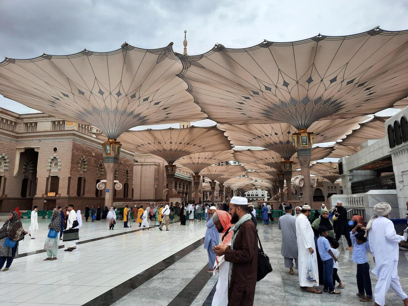 Madinah, Saudi Arabia, 29 March 2024 - Beautiful daytime outdoor view of Prophet's Mosque Madinah in dark clouds and rain. photo